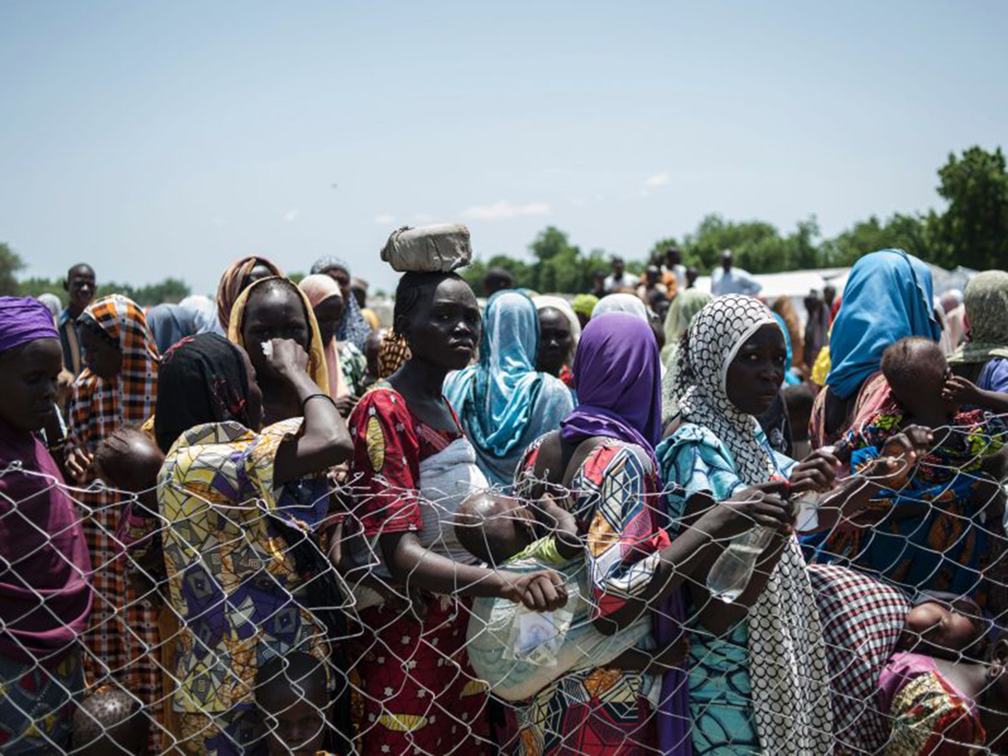 Women and children queue to enter one of the Unicef nutrition clinics in the Muna informal settlement, which now houses more than 16,000 people