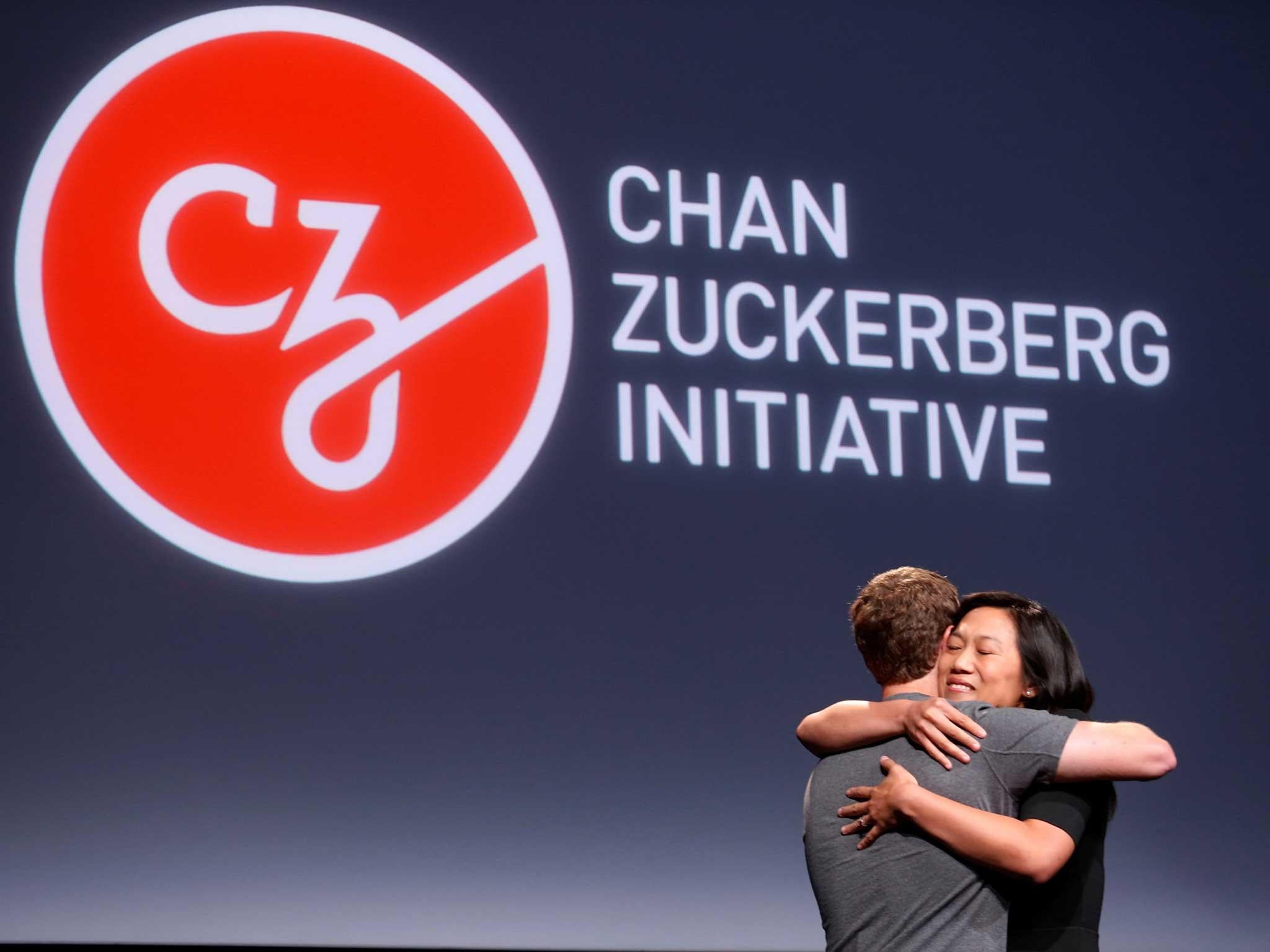 Priscilla Chan (R) embraces her husband Mark Zuckerberg while announcing the Chan Zuckerberg Initiative to "cure, prevent or manage all disease" by the end of the century during a news conference at UCSF Mission Bay in San Francisco, California, U.S. September 21, 2016.