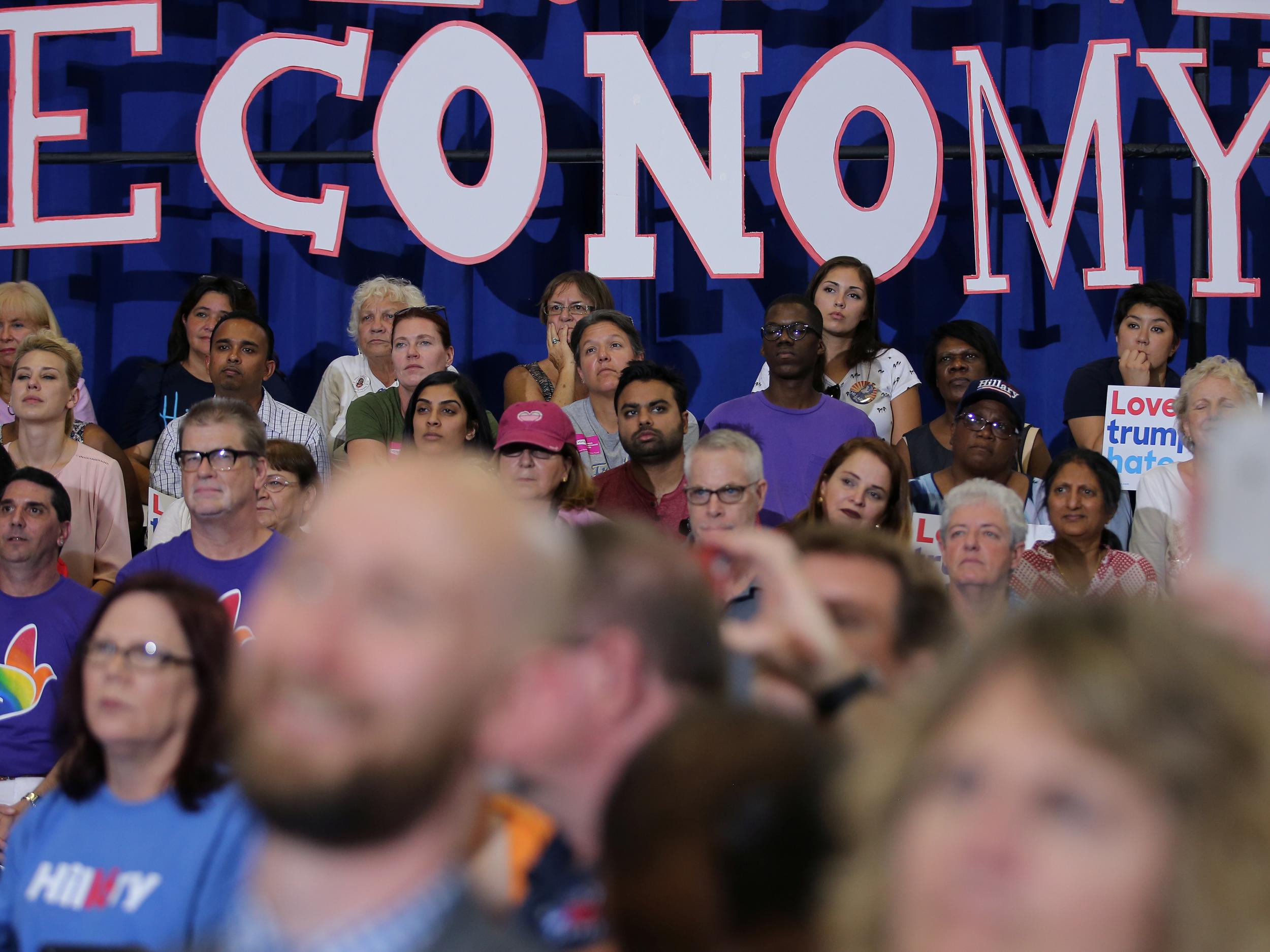 Local residents listen as Hillary Clinton speaks during a campaign event in Orlando on Wednesday 21 September