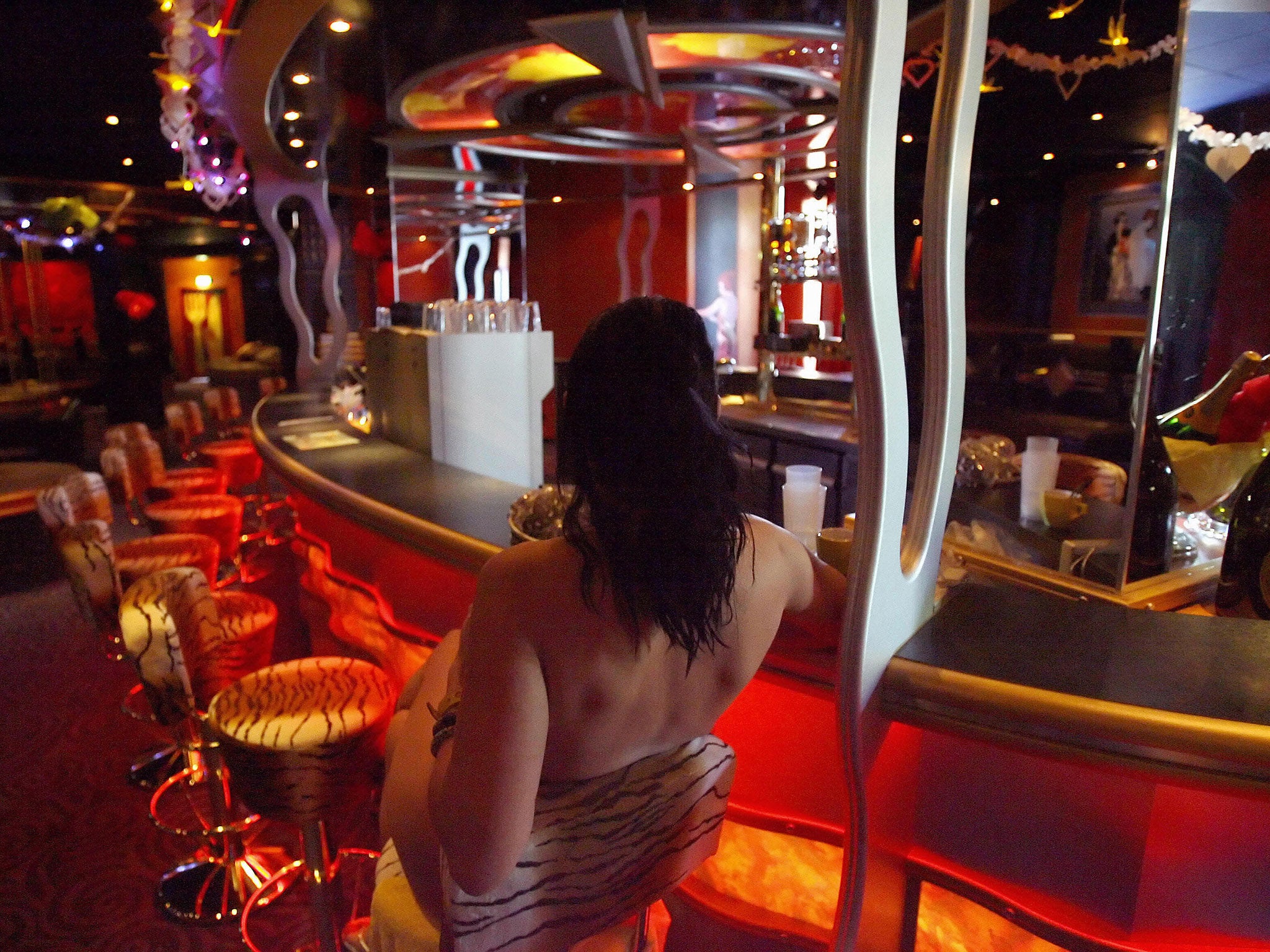 A sex worker at the bar of Berlin's Artemis brothel 04 May 2006. (AFP/Getty Images)