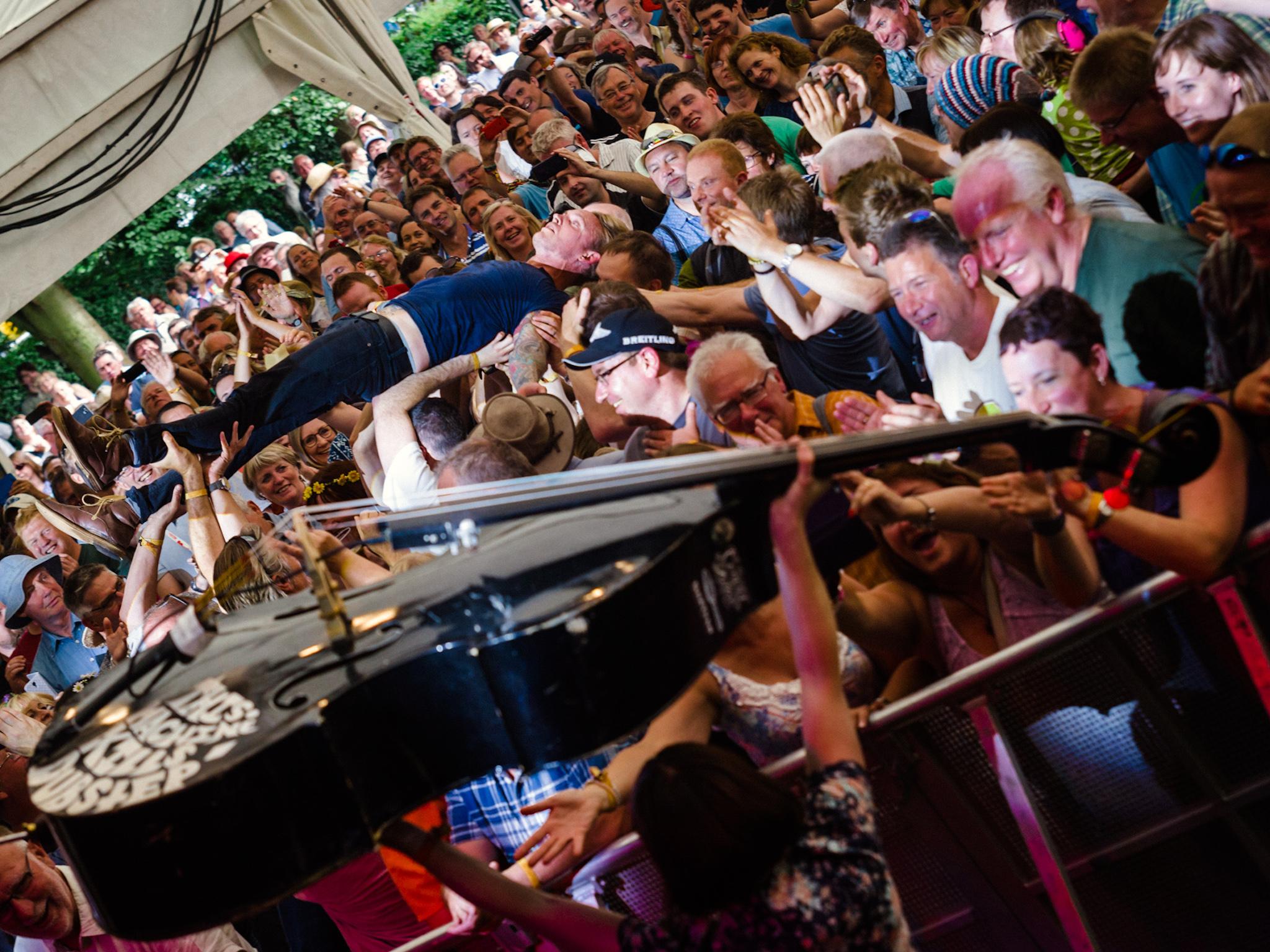 &#13;
Lorna Thomas gets ready to pass the double bass to Camino in the crowd at the Cambridge Folk Festival last year &#13;