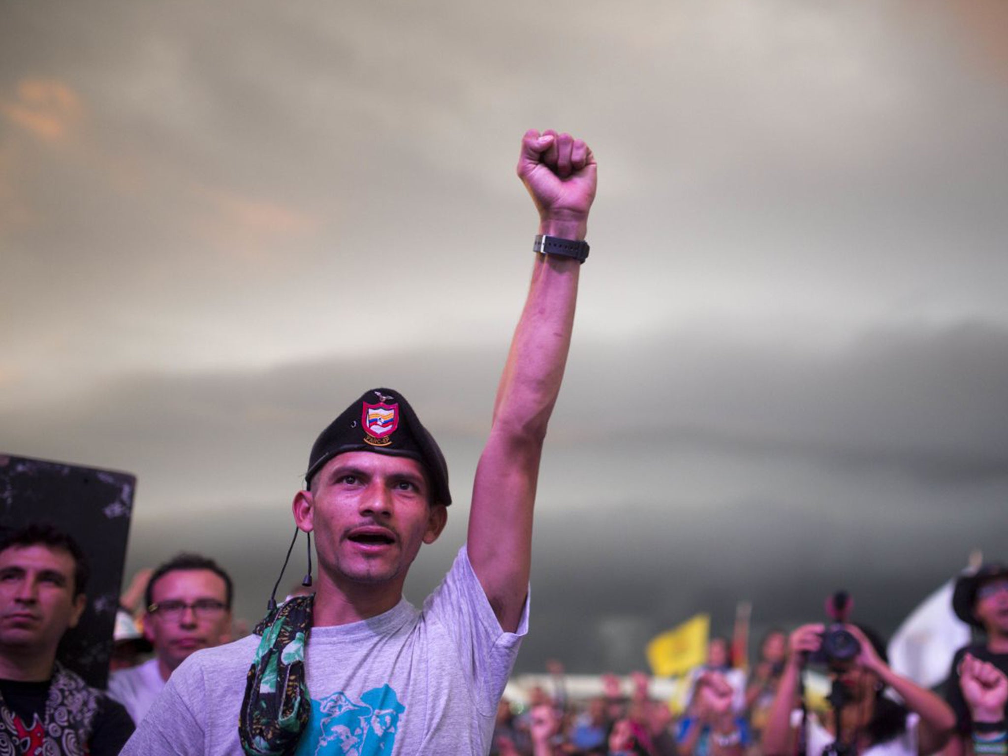 People cheer during the closing event of the 10th conference held by the Revolutionary Armed Forces of Colombia, FARC, in Yari Plains, Colombia, yesterday