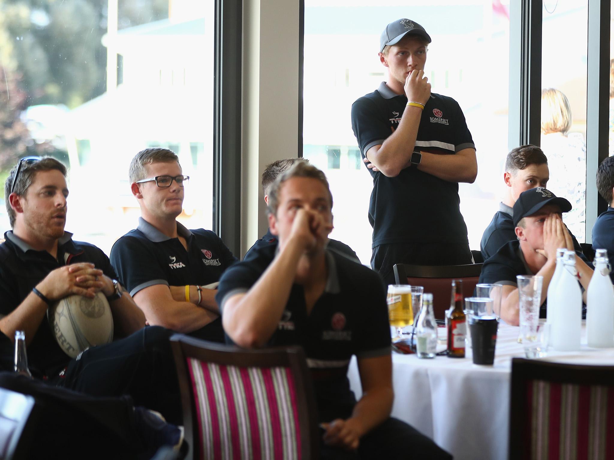 The Somerset squad watch Middlesex take their final wicket to win the County Championship