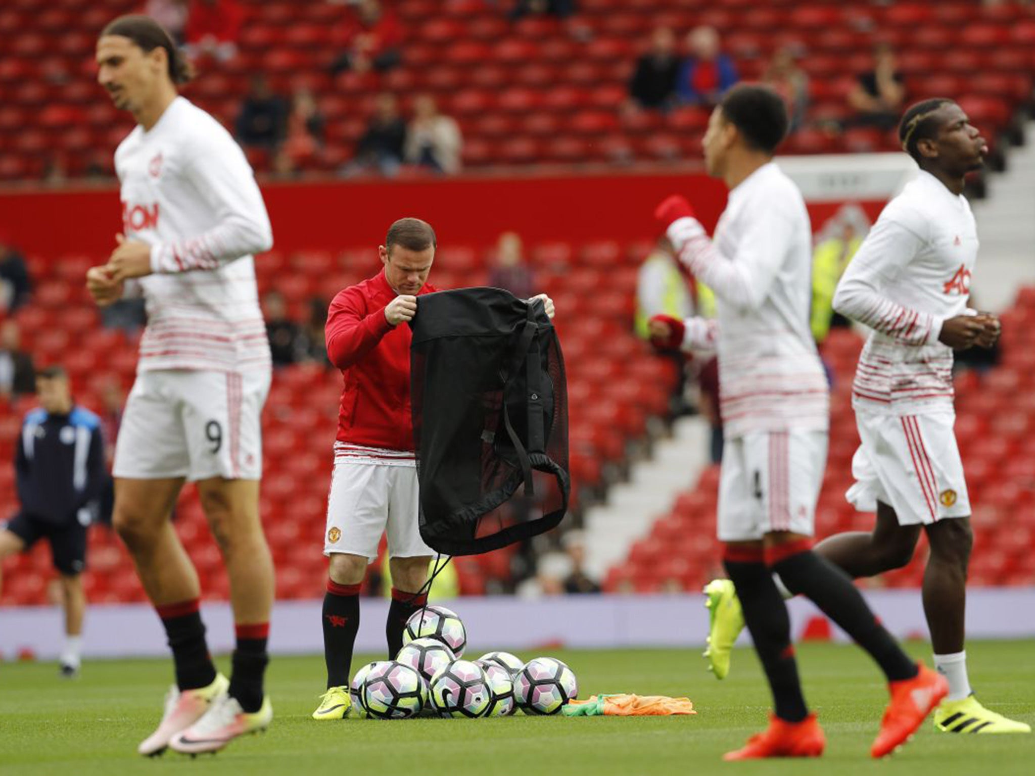 Rooney looked on as his team-mates warmed up on Saturday