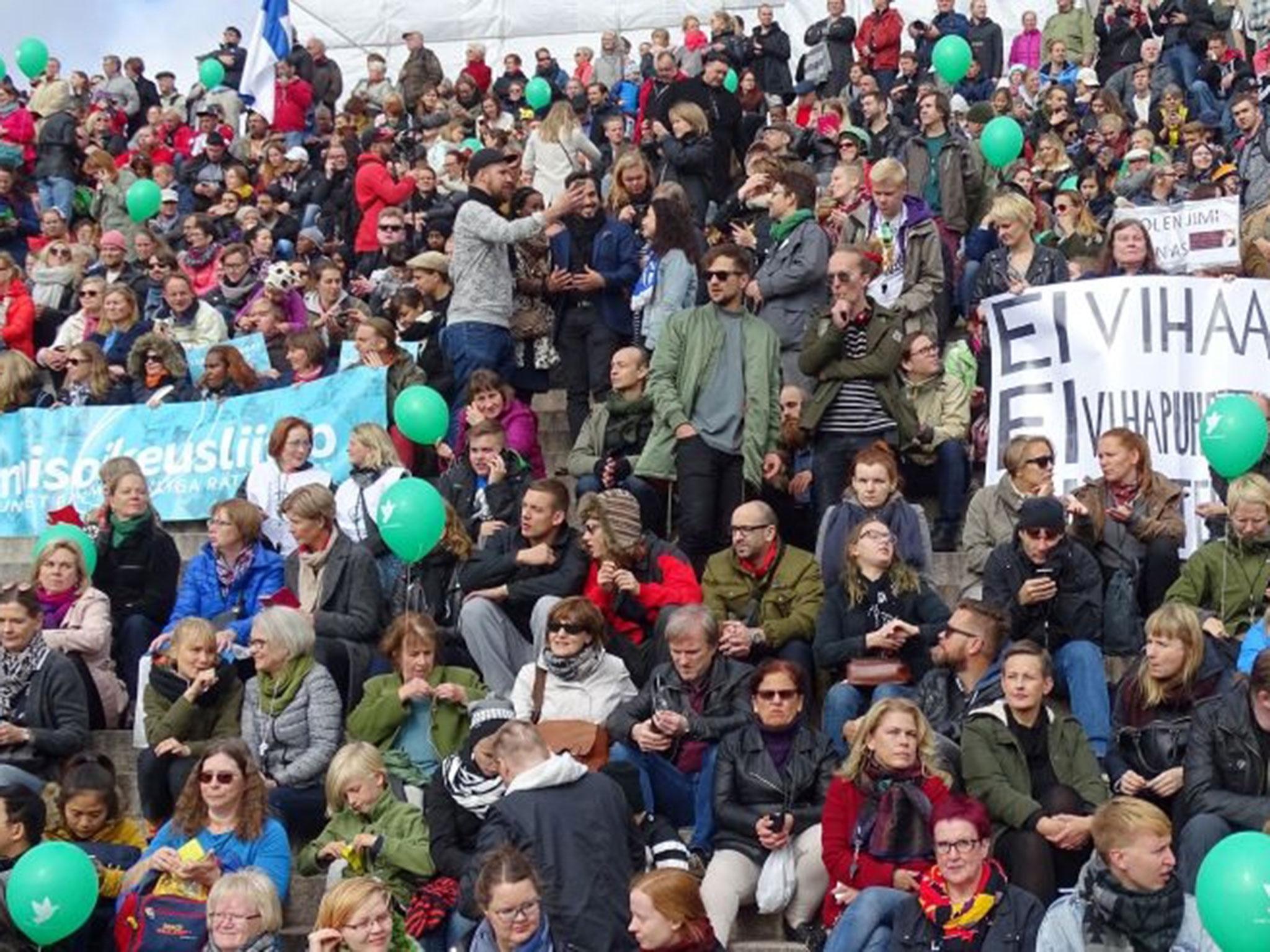 Participants and spectators held green balloons and signs reading "No to Nazism" during a demonstration against racism and far right movements in downtown Helsinki, Finland, 24 September, 2016