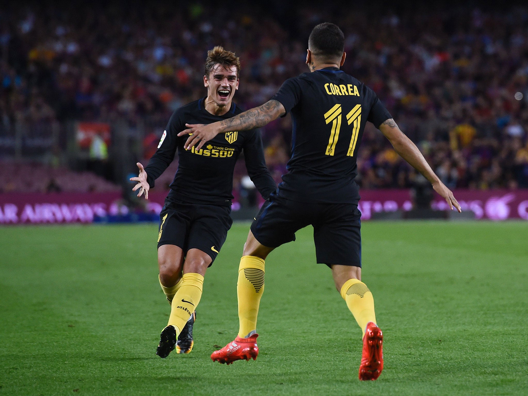 Atletico Madrid's Angel Correa celebrates his goal against Barcelona with Griezmann