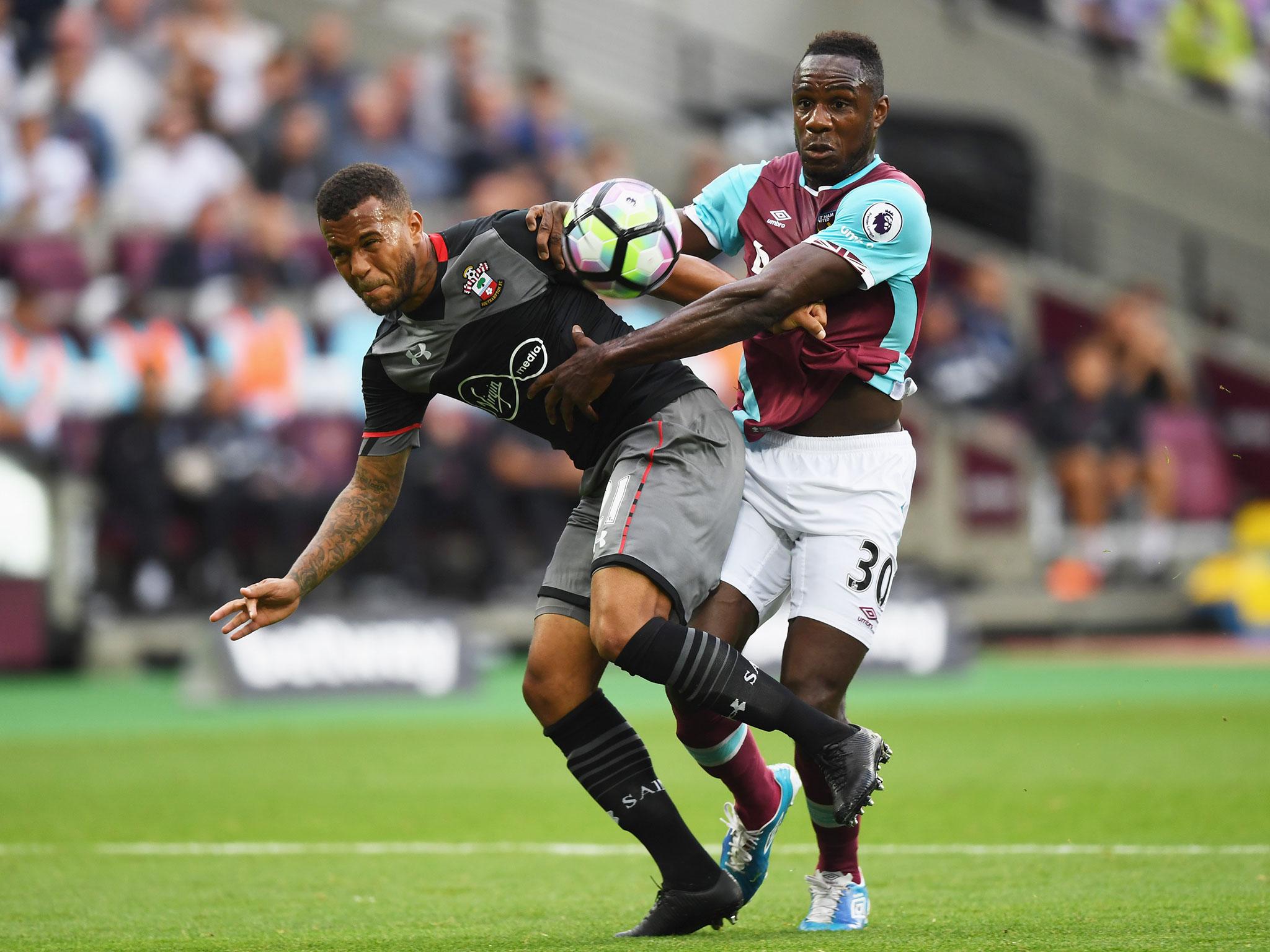 Michail Antonio tussles for the ball