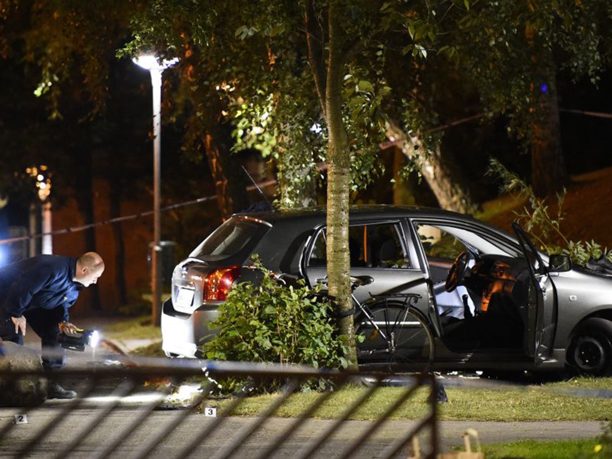 Police examine the scene of a shooting in southern Malmo