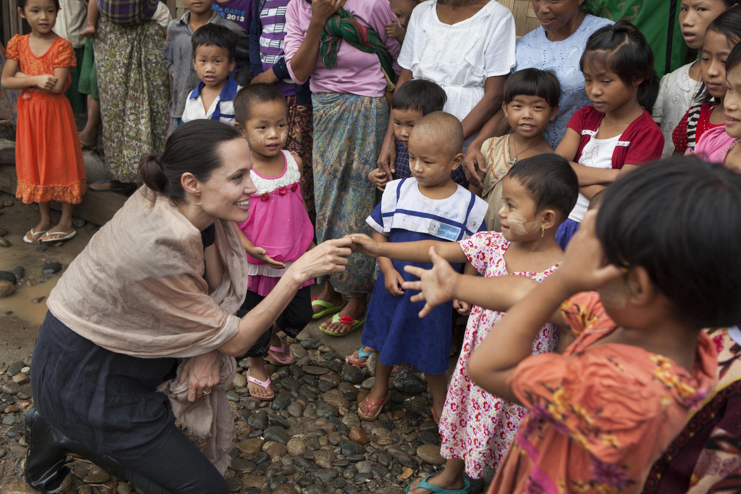 Jolie greeting children in Cambodia (Tom Stoddart/Getty)