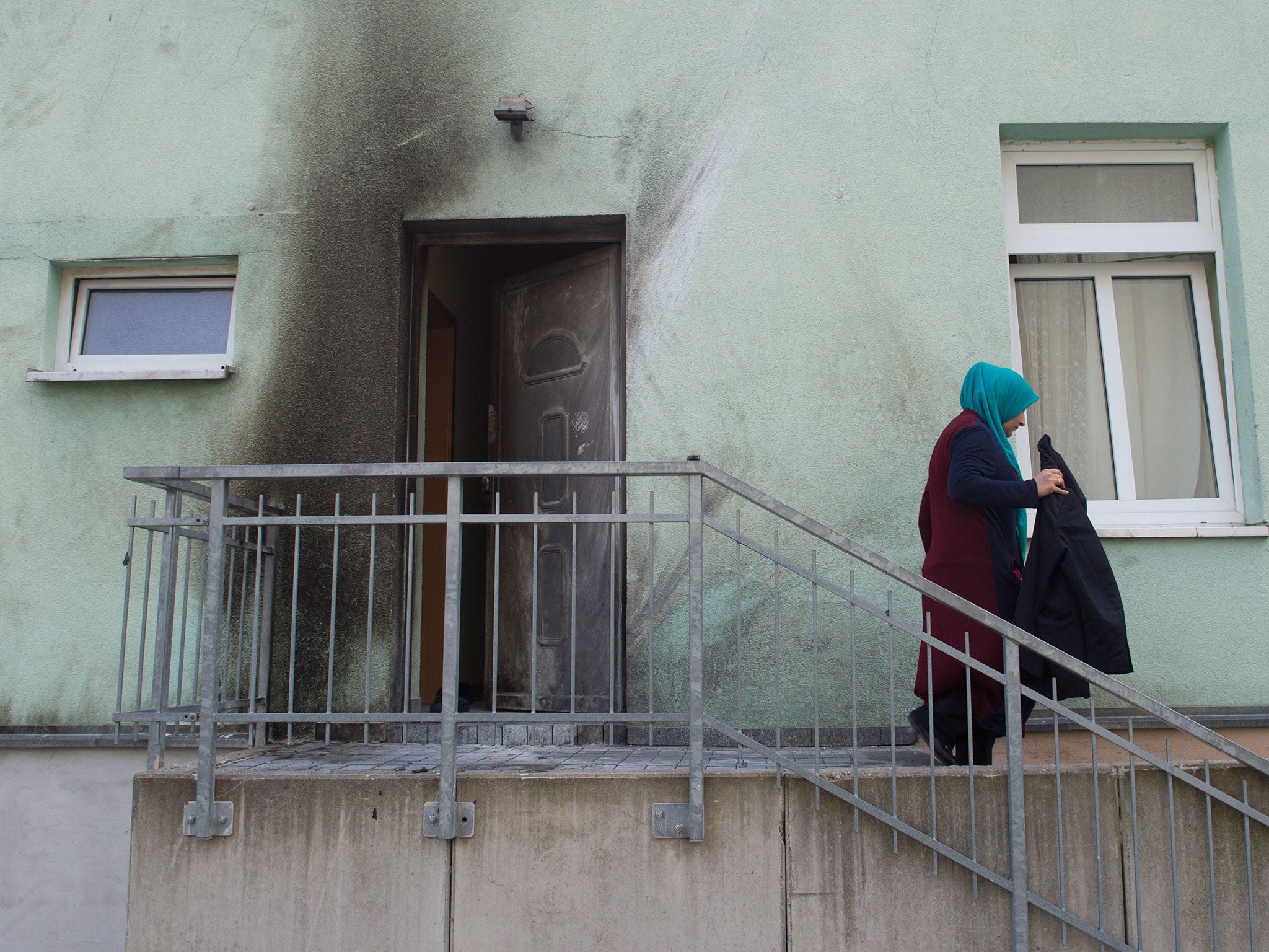 Traces of an explosion stain the wall and a door of the Fatih Camii mosque in Dresden on 27 September 2016