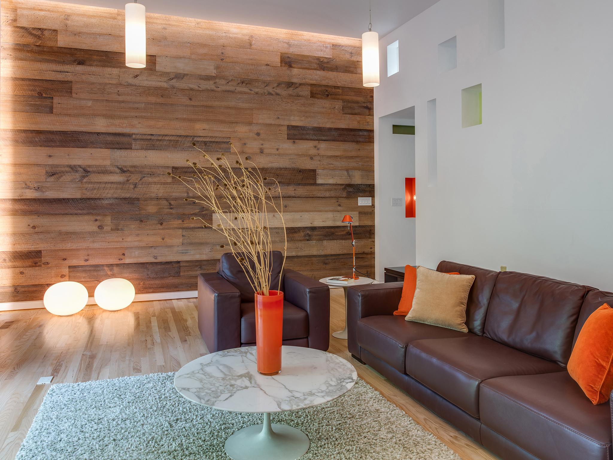 A warm wall of wood faces the basalt fireplace surround on the other side of the room (Washington Post)