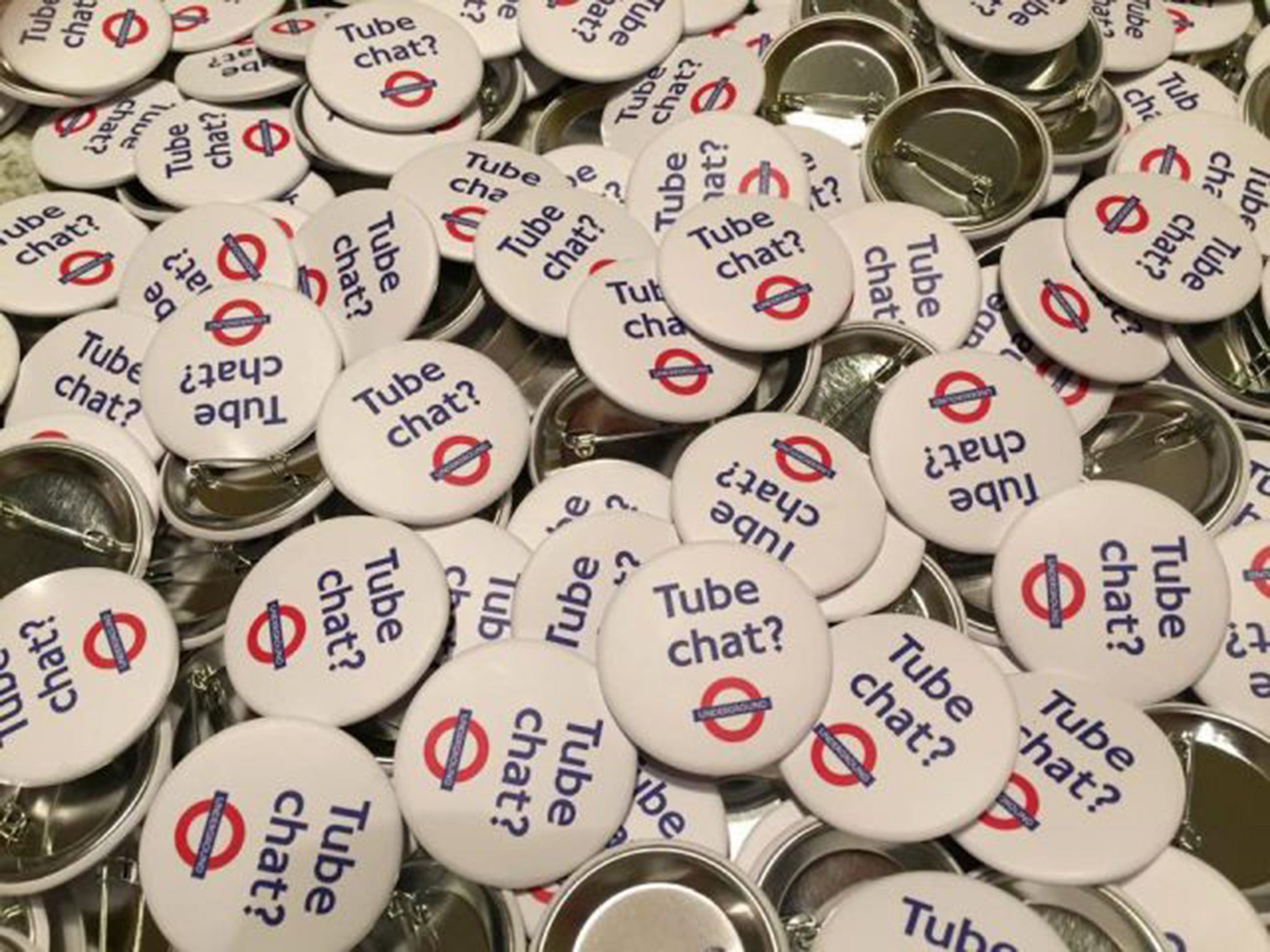 People were given badges that encourage strangers to talk to each other on the London Underground