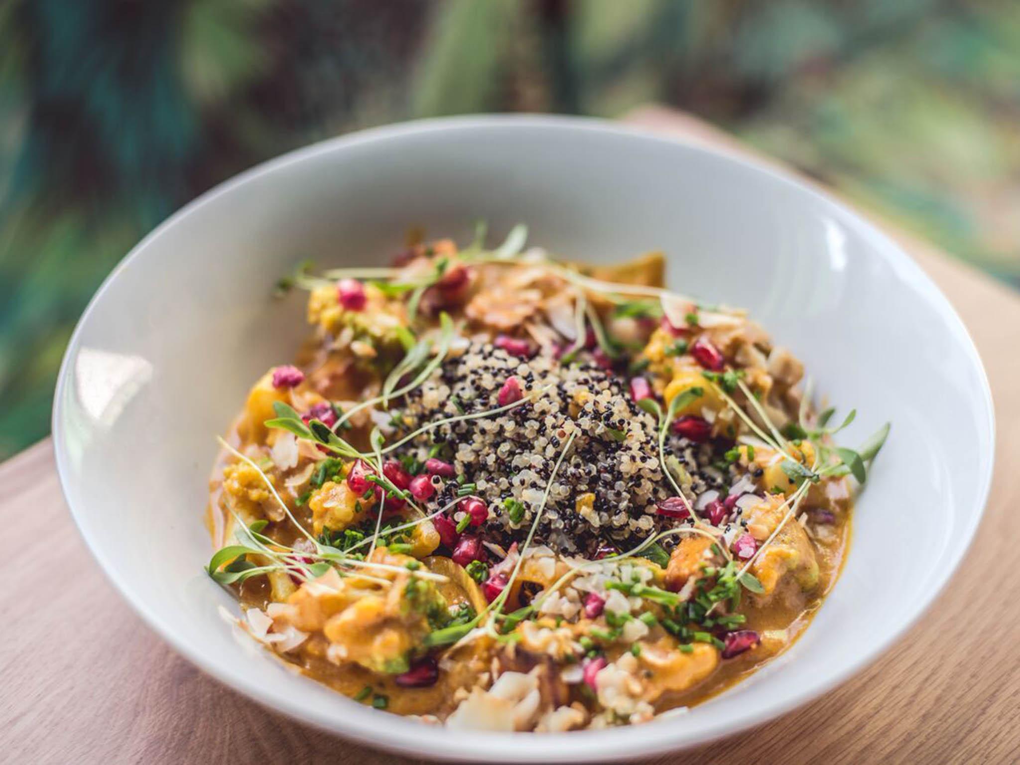 Coconut, sweet potato and pumpkin curry with quinoa, tomato, pomegranate and coconut flakes