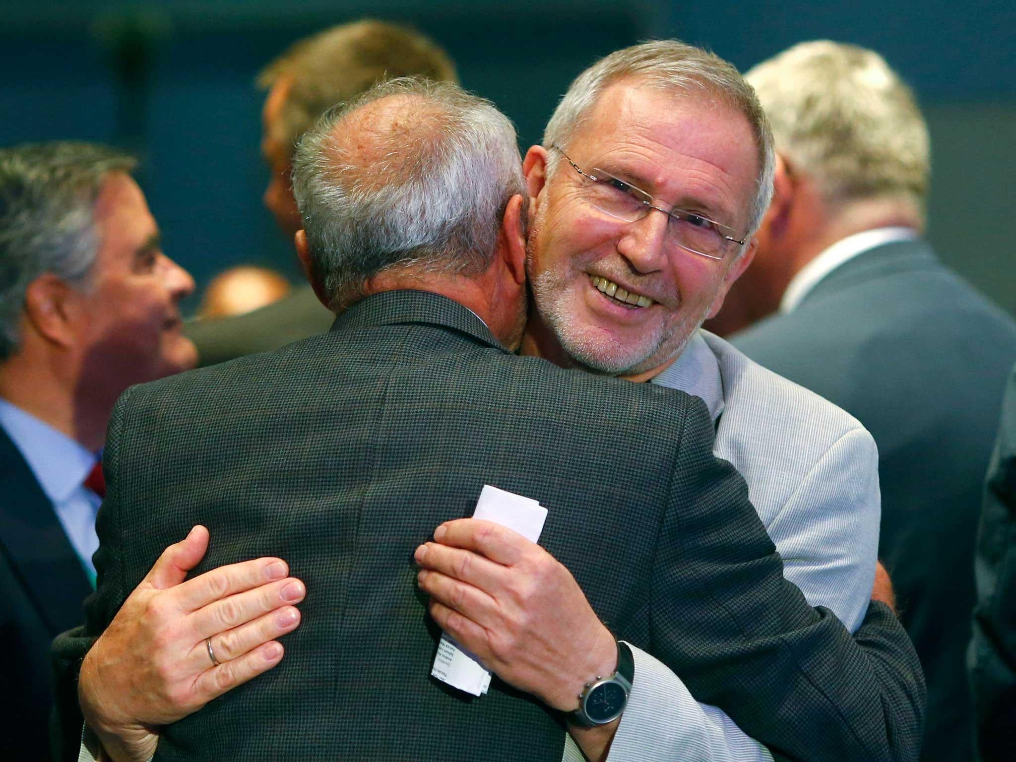 Gerhard Schwehm (2ndR) embraces Berndt Feuerbacher at the European Space Agency's (ESA) headquarters in Darmstadt,