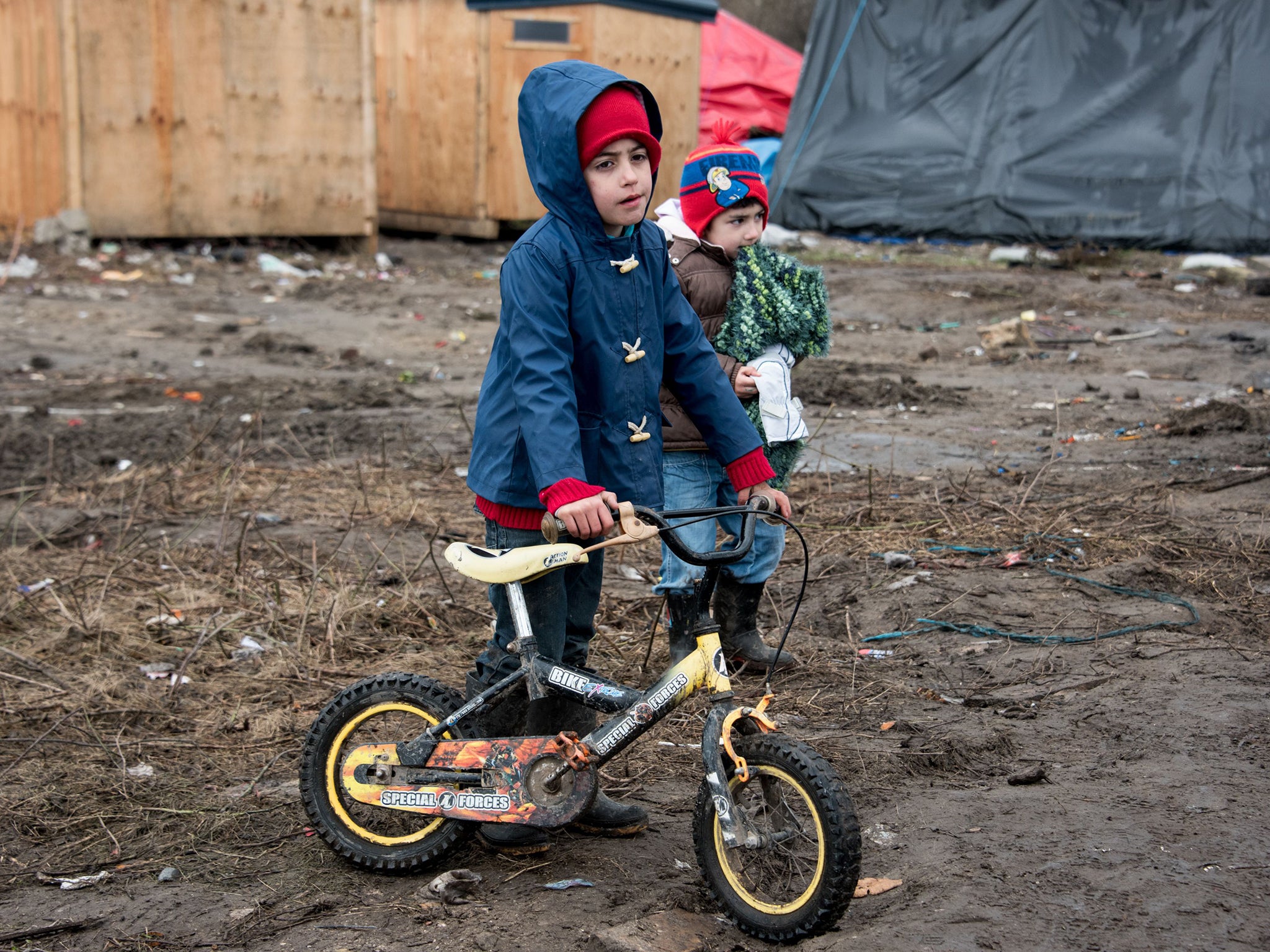 Refugee children playing in the Calais camp which Francois Hollande has vowed to close by the end of the year