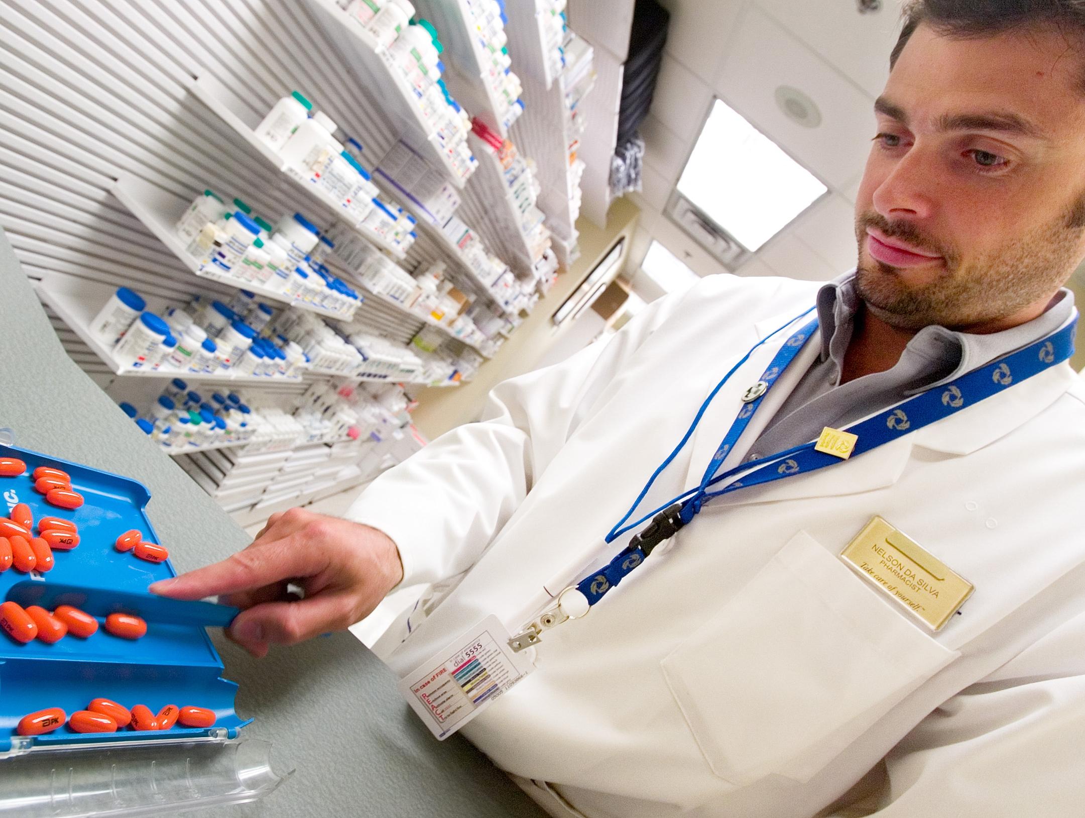 A pharmacist dispenses HIV drugs