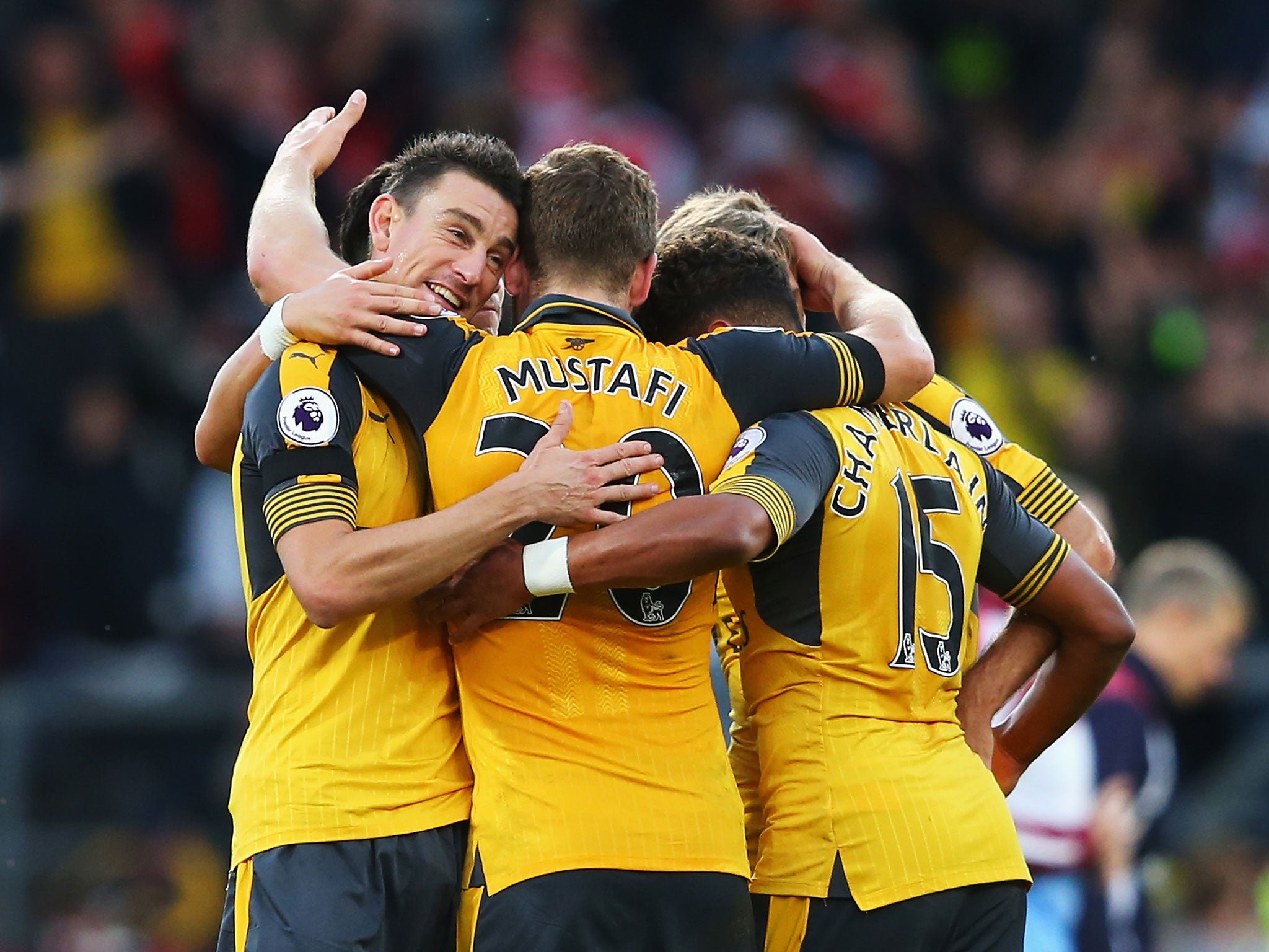 Laurent Koscielny is congratulated by his team mates on his late goal