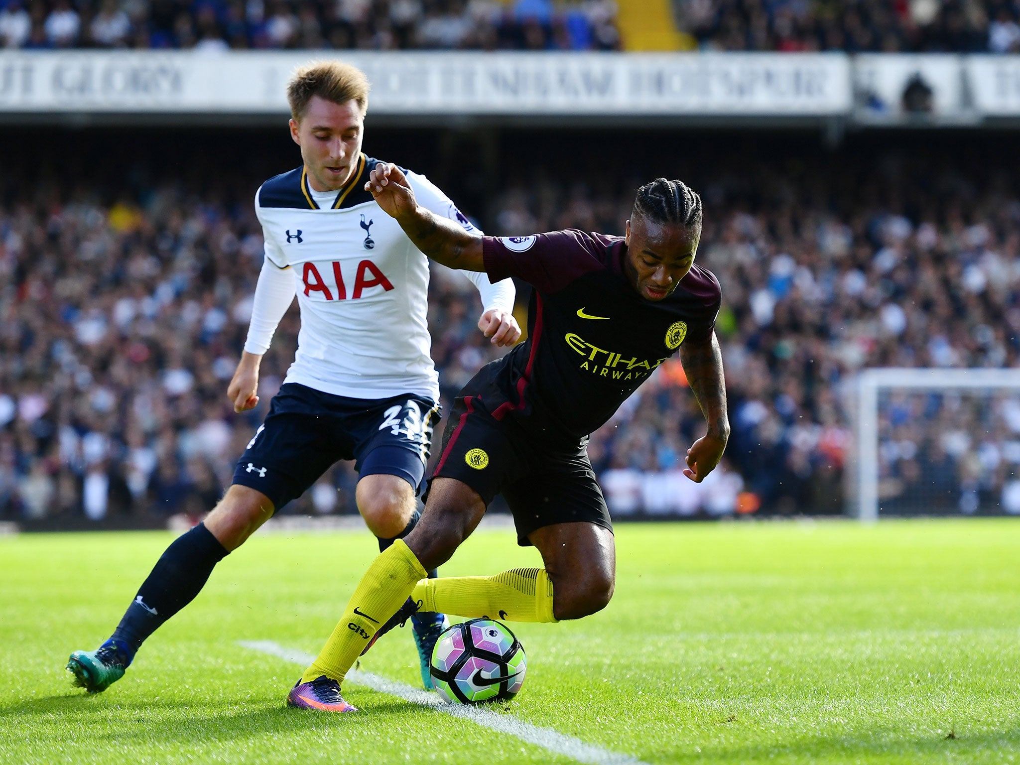 Raheem Sterling looks to get away from Christian Eriksen