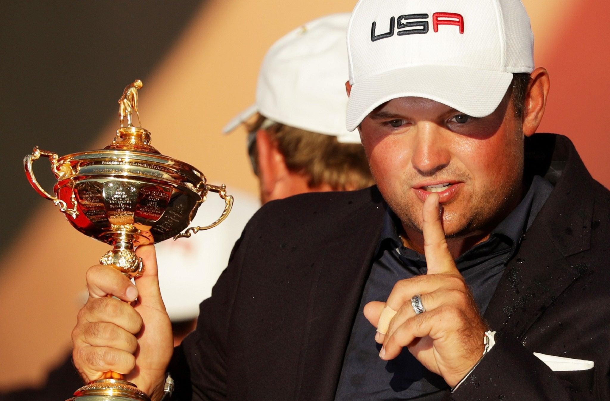 Patrick Reed repeats his 'shh' celebration while holding the Sam Ryder Cup