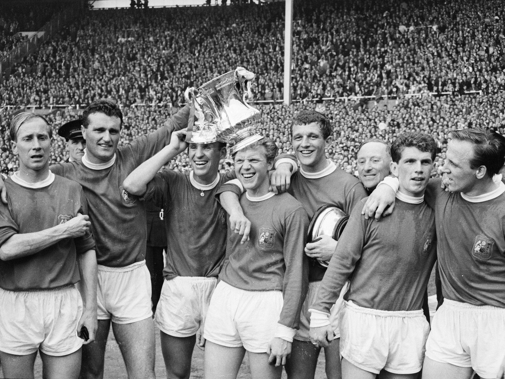 Members of the Manchester United football team celebrating after beating Leicester City in the FA Cup final, May 1963, including (from left) Bobby Charlton, Noel Cantwell, Pat Crerand, Albert Quixall and David Herd.