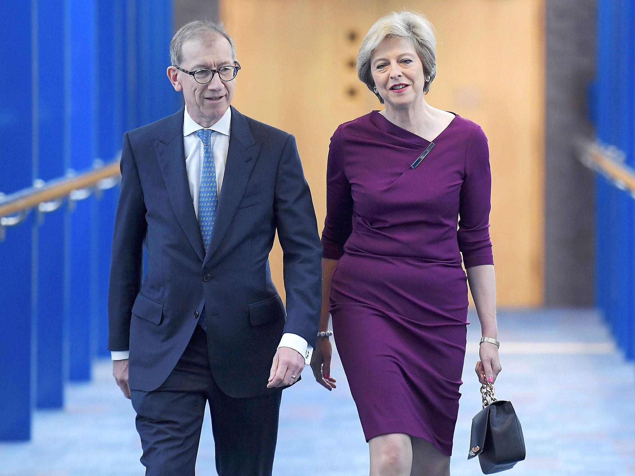 Britain's Prime Minister Theresa May and her husband Philip arrive on the final day of the annual Conservative Party Conference in Birmingham