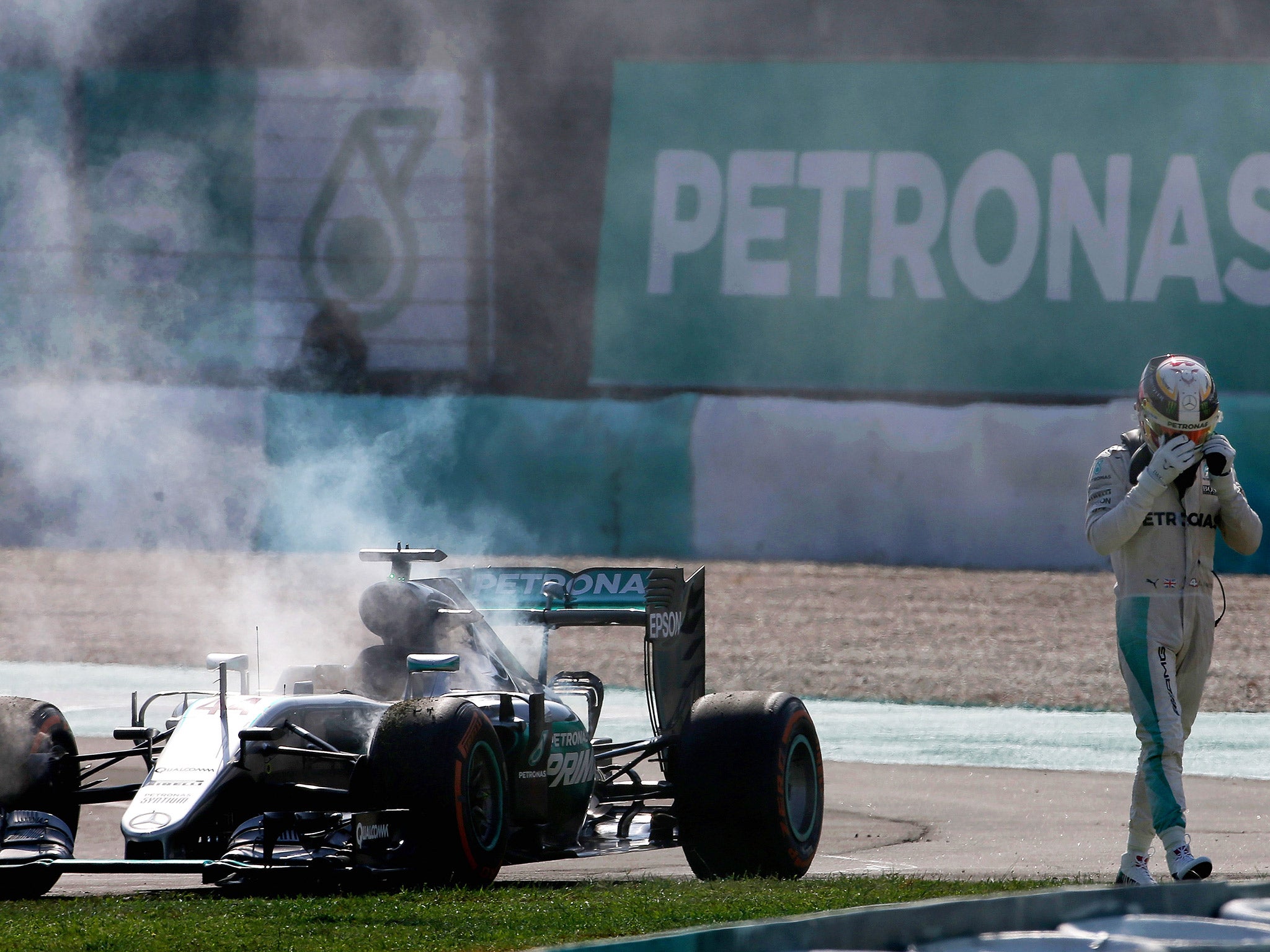 &#13;
Hamilton walks away dejectedly after his Mercedes blew its engine in Malaysia &#13;