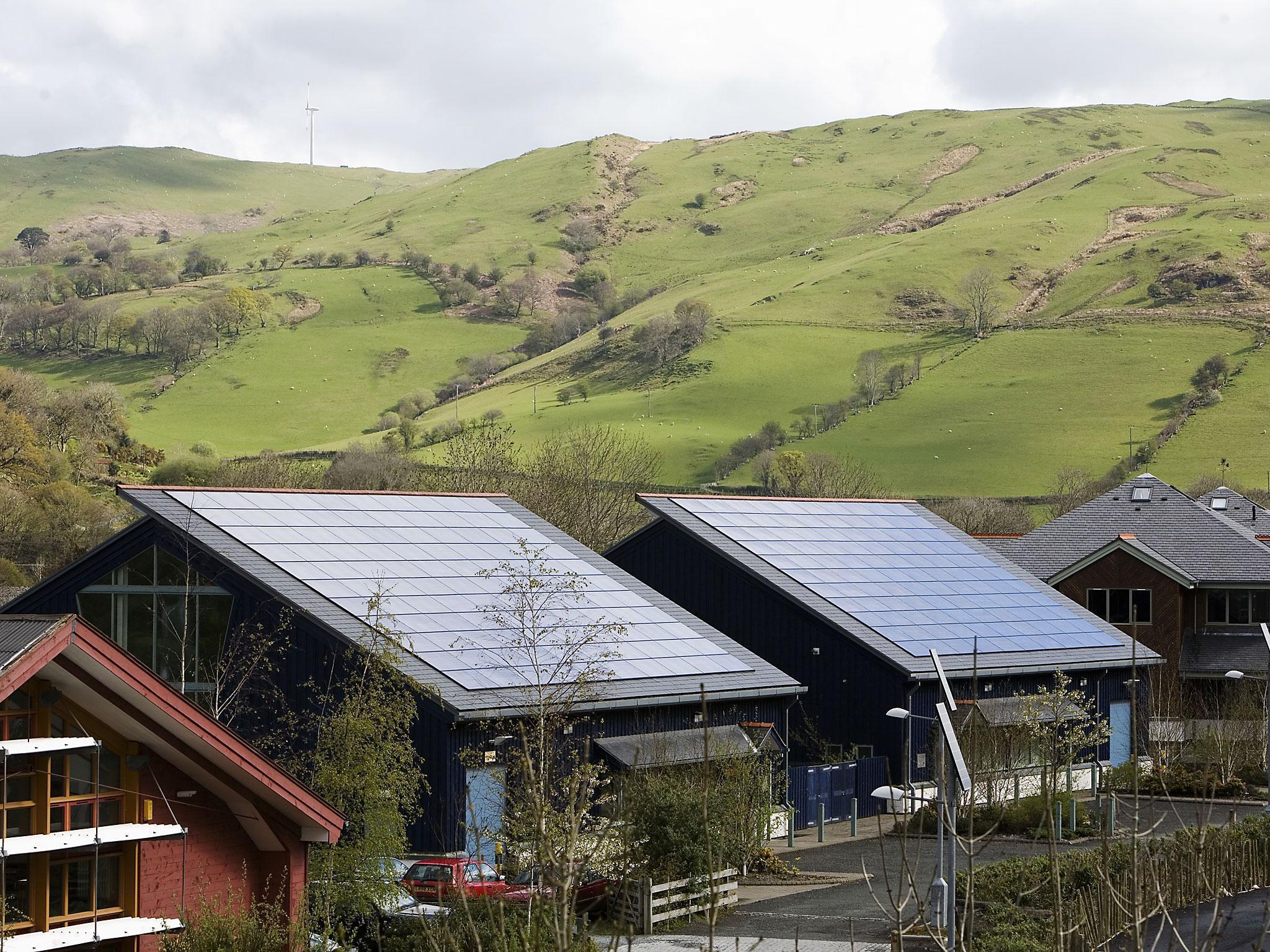 Roofs tiled with photovoltaic solar energy panels receive maximum sunlight exposure in Dyfi Eco Park, Machynlleth, Wales. These panels are made up of photovoltaic (PV) cells. PV cells convert sunlight into electrical energy