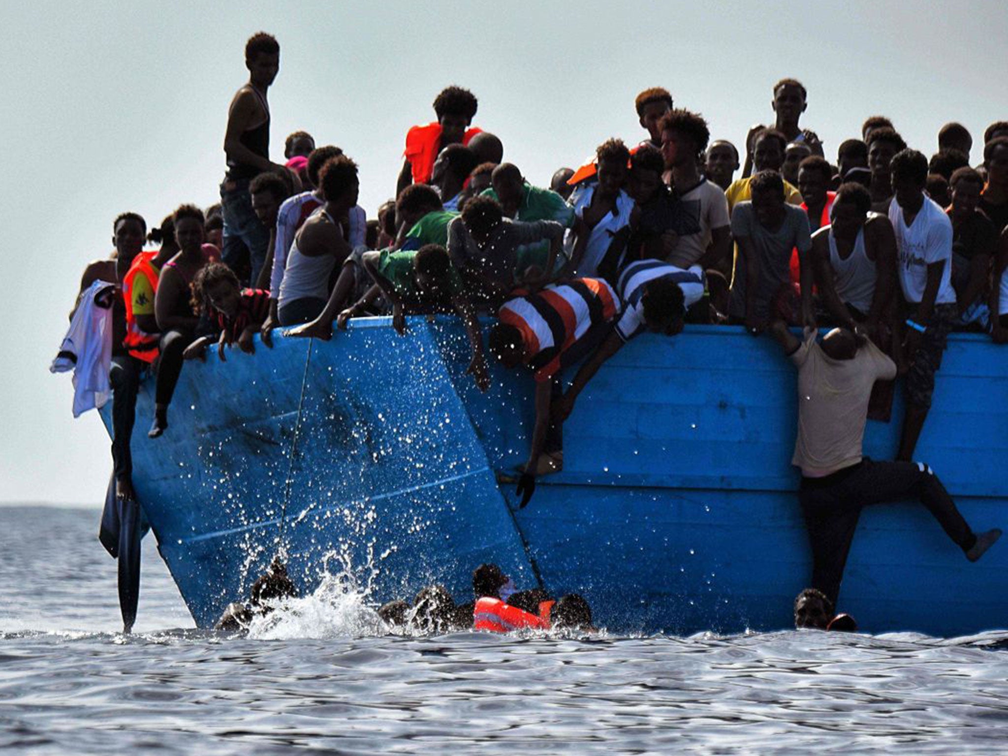 Refugees struggle not to drown as they wait to be rescued in the Mediterranean Sea, north of Libya on 4 October 2016.