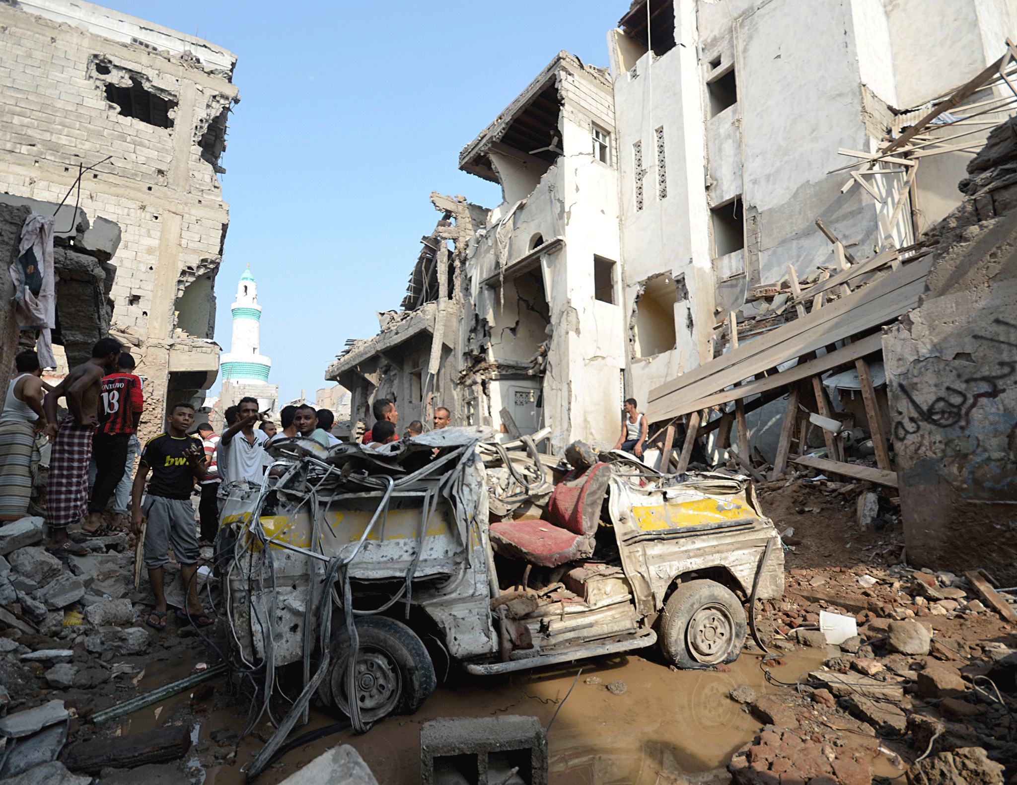 People gather at the site of a Saudi-led air strike in the Red Sea port city of Hodeidah