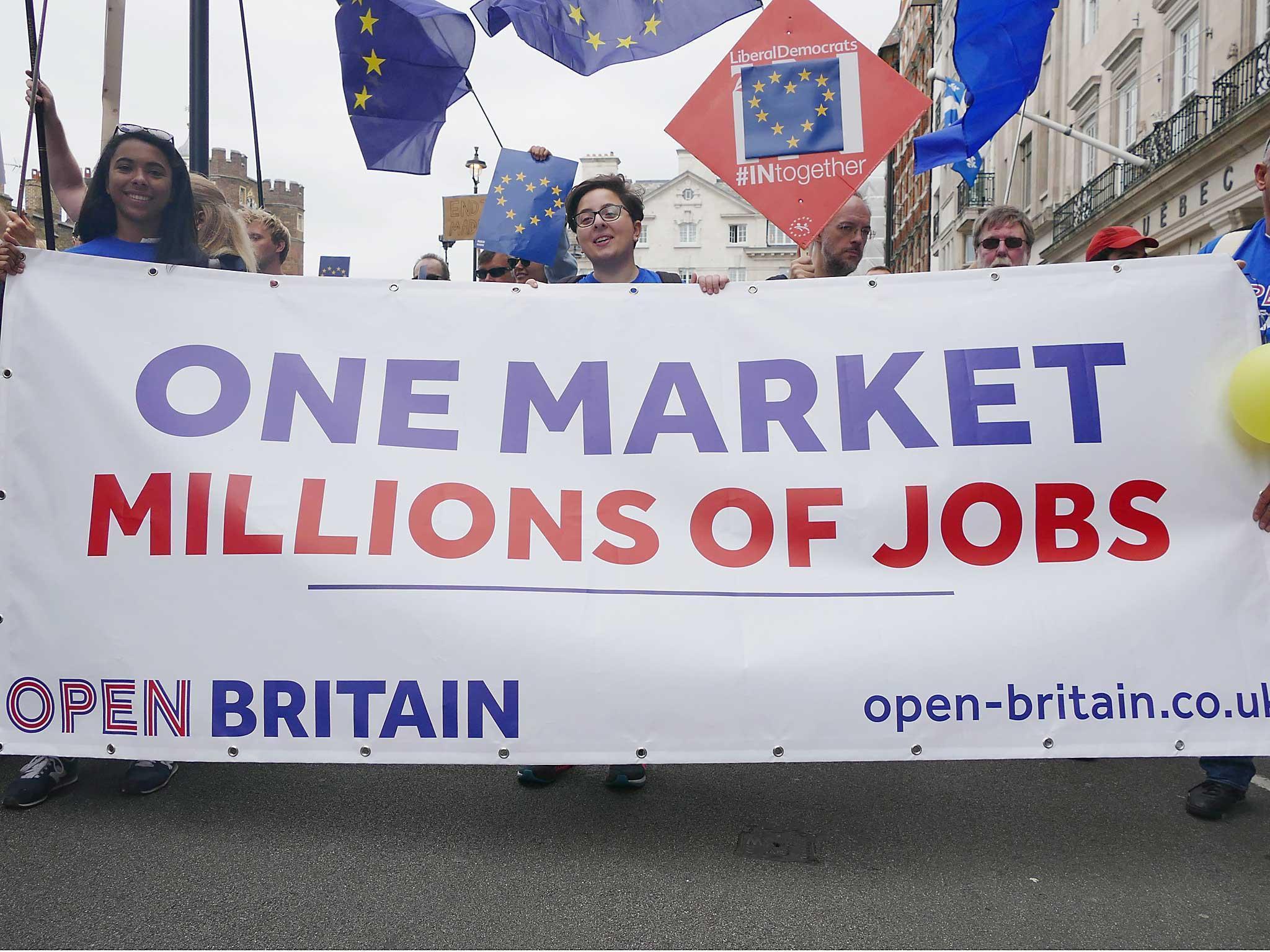 Demonstrators on the anti-Brexit March for Europe hold EU flags as they march to Parliament Square in central London