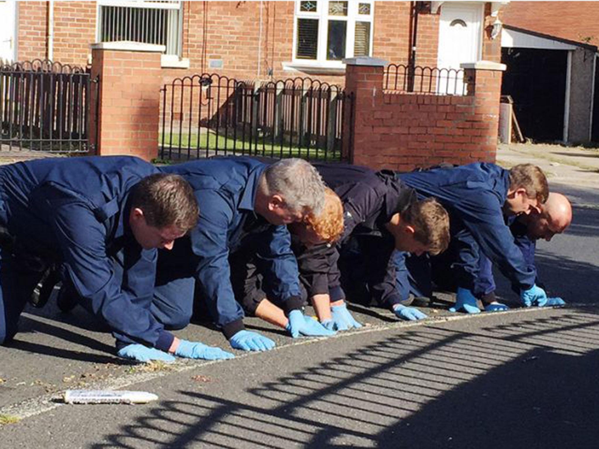 Police carry out a fingertip search of Hewitt Avenue in Sunderland where a 15-year-old boy was shot