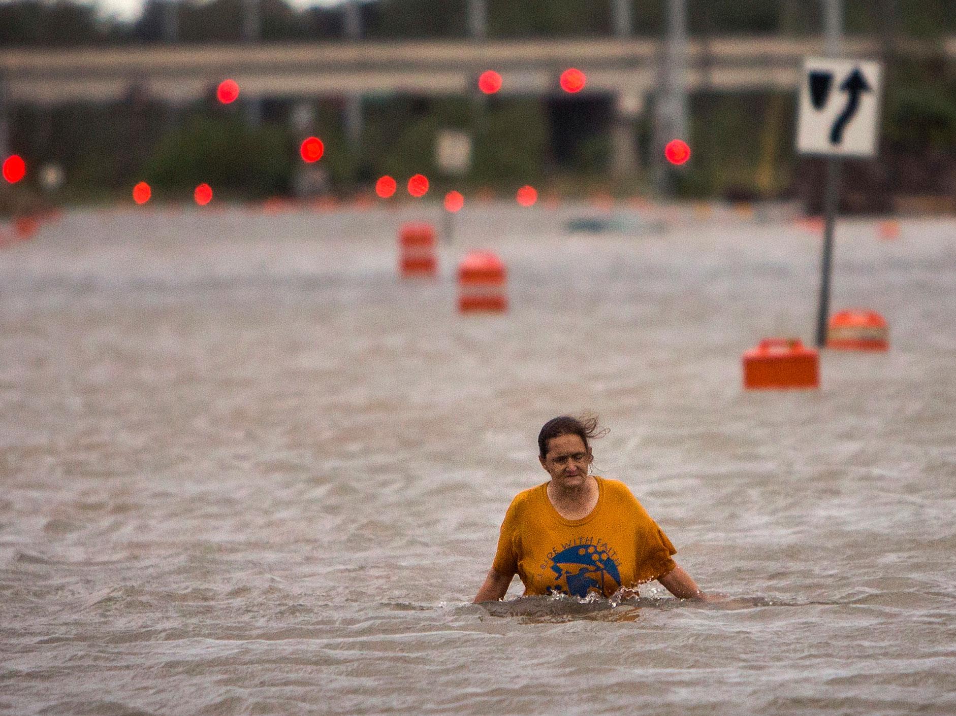 A woman wades through water as Georgia experiences massive flooding from Hurrican Matthew AP