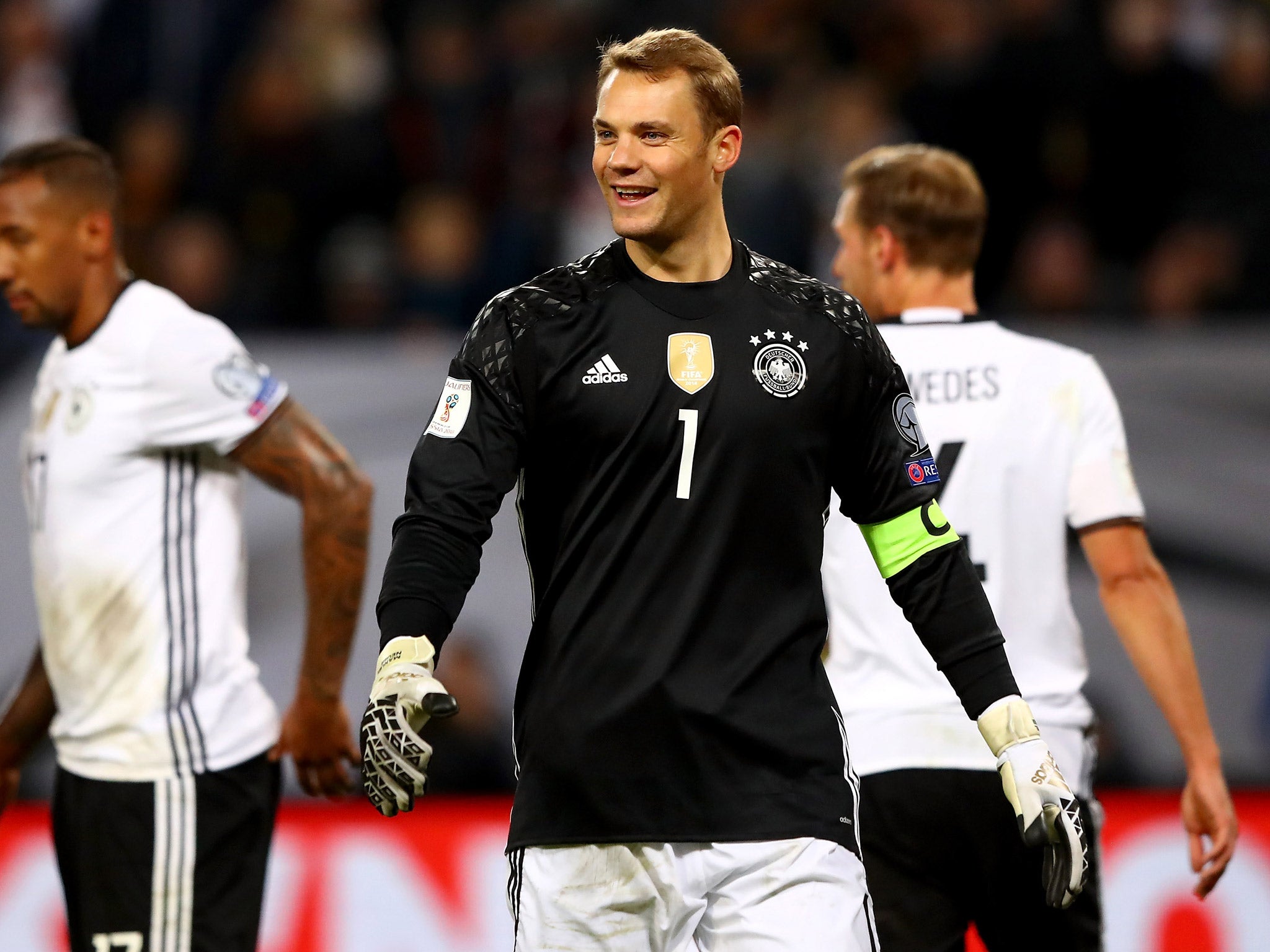 Manuel Neuer laughs to himself after managing to kick the ball into his own face