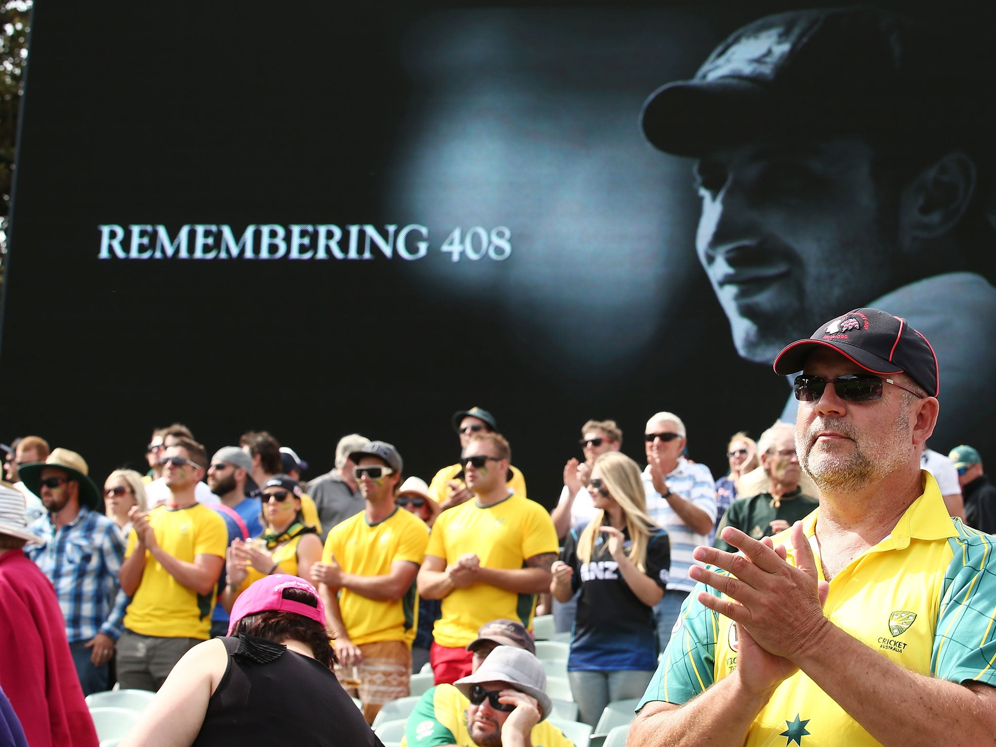 Spectators pay tribute to former cricketer Phillip Hughes at eight minutes past four during day one of the Third Test match between Australia and New Zealand at Adelaide Oval on November 27, 2015