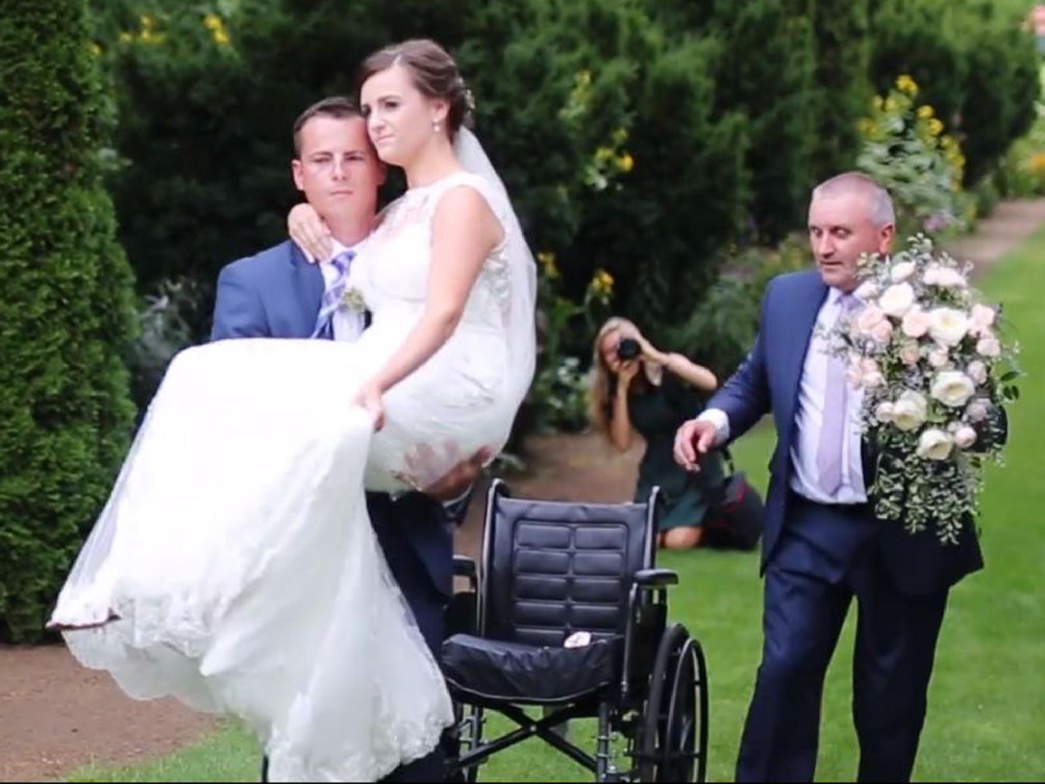 Hannah Patterson is carried down the aisle by husband-to-be Stuart