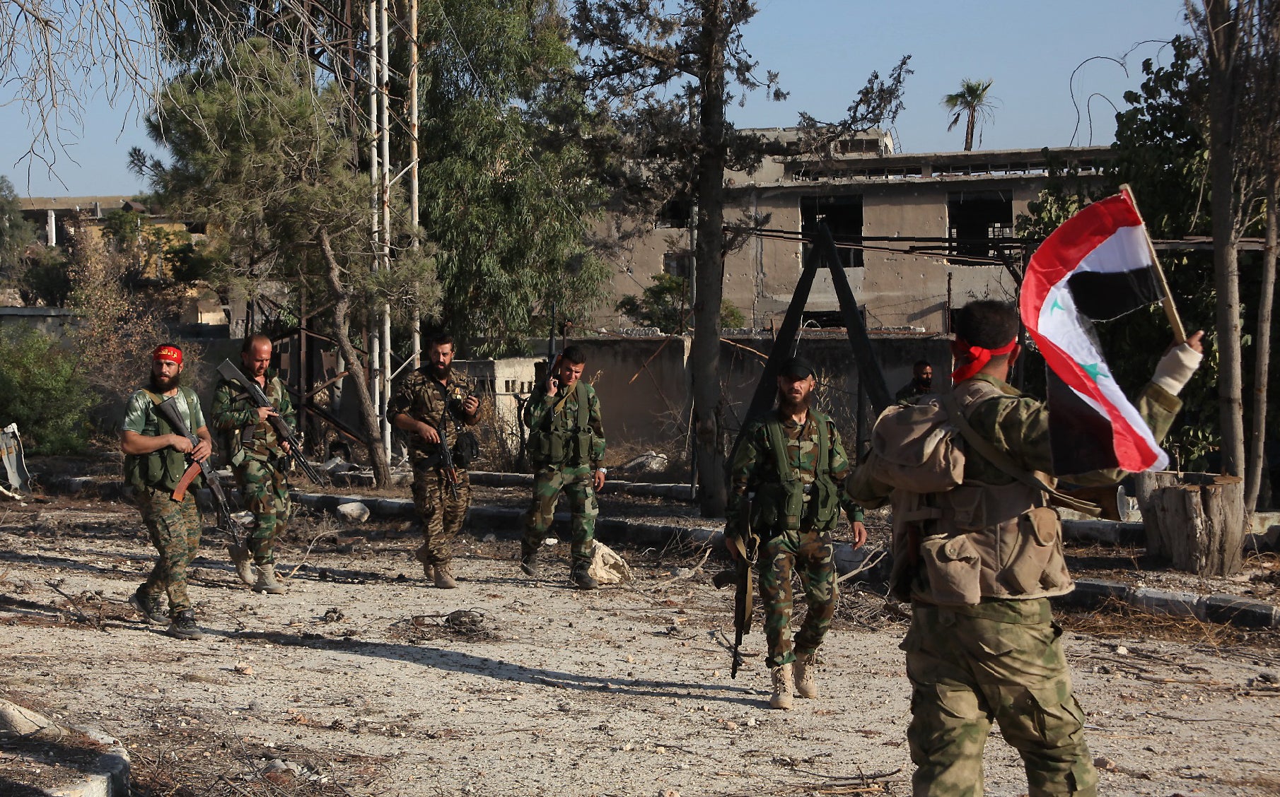 Syrian pro-government soldiers patrol the Uwaija neighbourhood as they advance in Aleppo's rebel-held areas