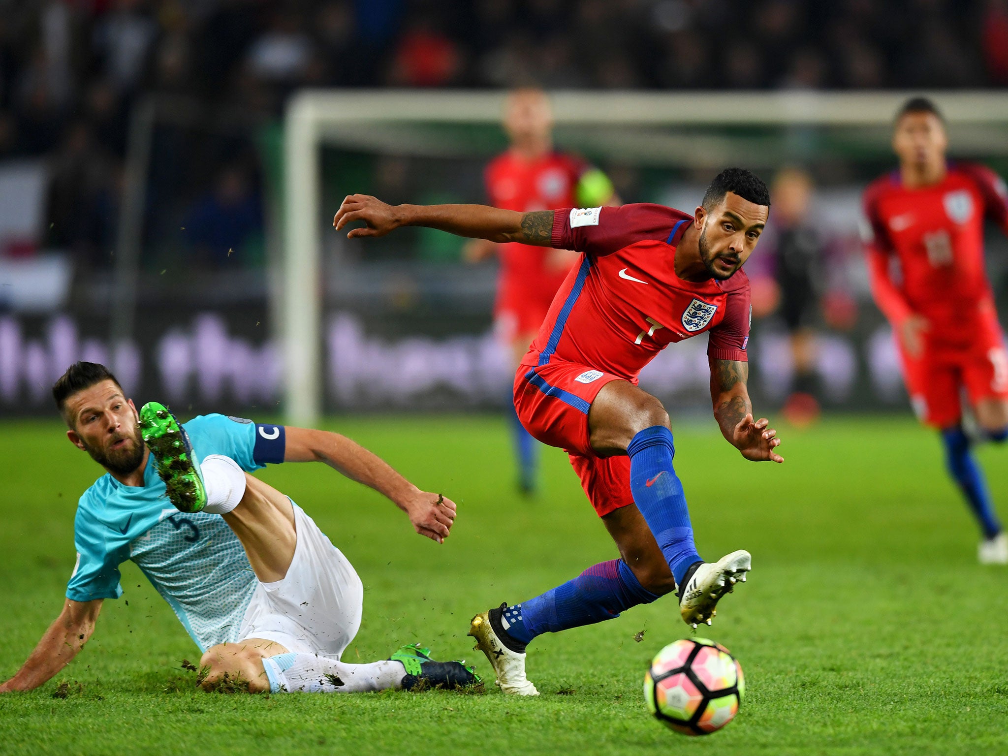 Theo Walcott battles to regain possession against Slovenia on Tuesday night