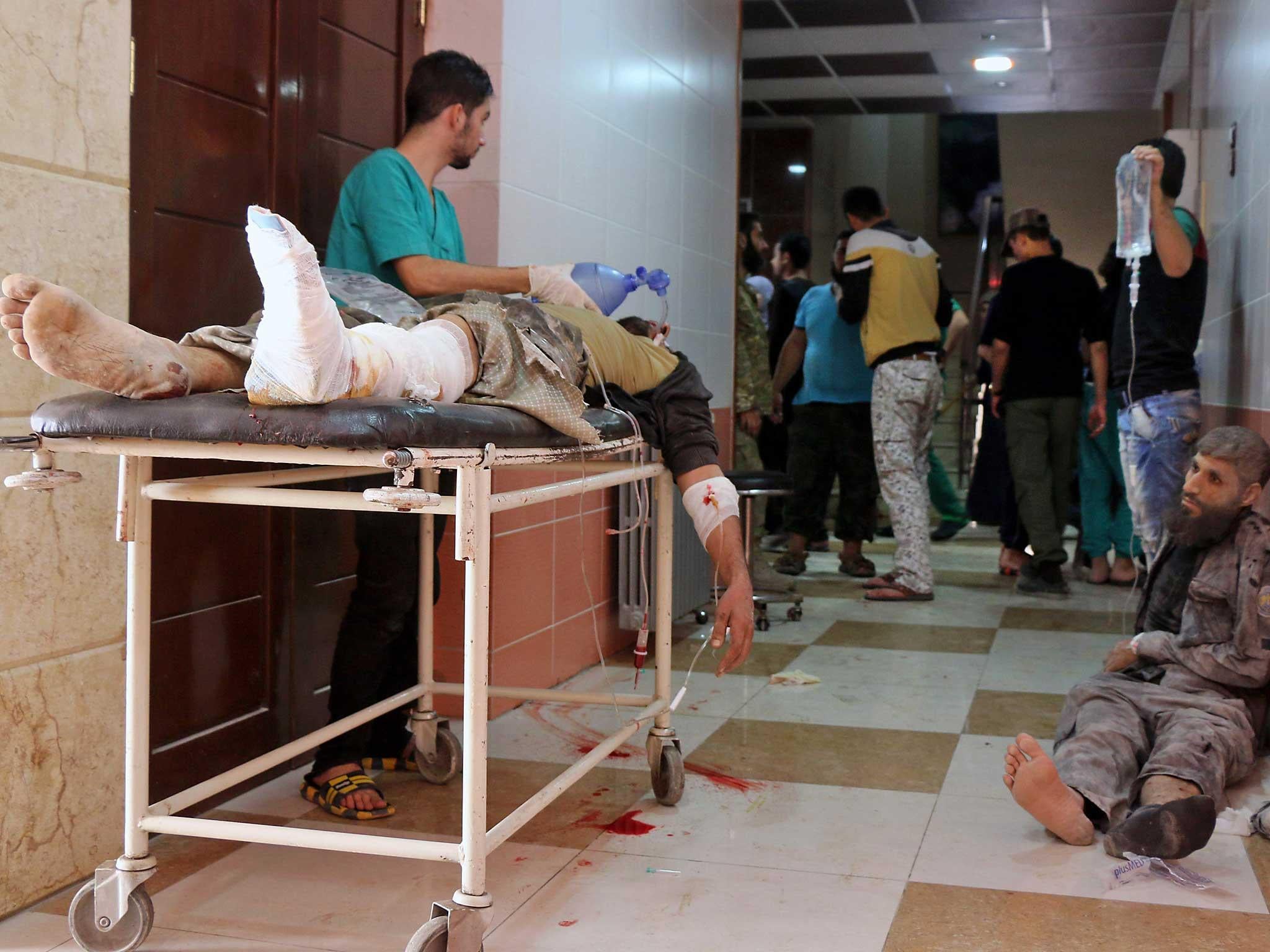 Syrians wait to receive treatment at a hospital following Russian air strikes on the rebel-held Fardous neighbourhood of the northern embattled Syrian city of Alepp