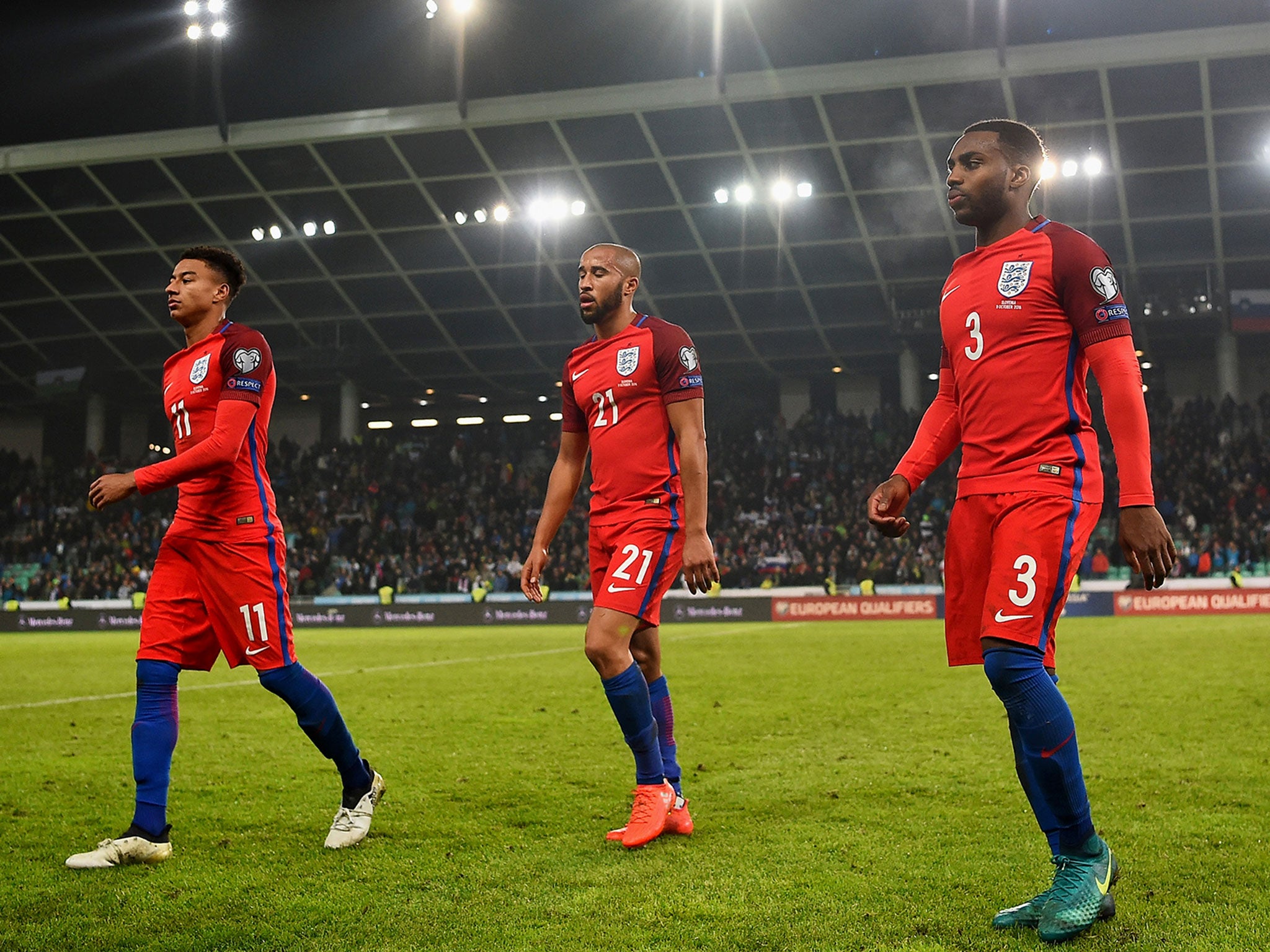 Jesse Lingard and Danny Rose (either side of Andros Townsend) leave the pitch at the end of the draw with Slovenia