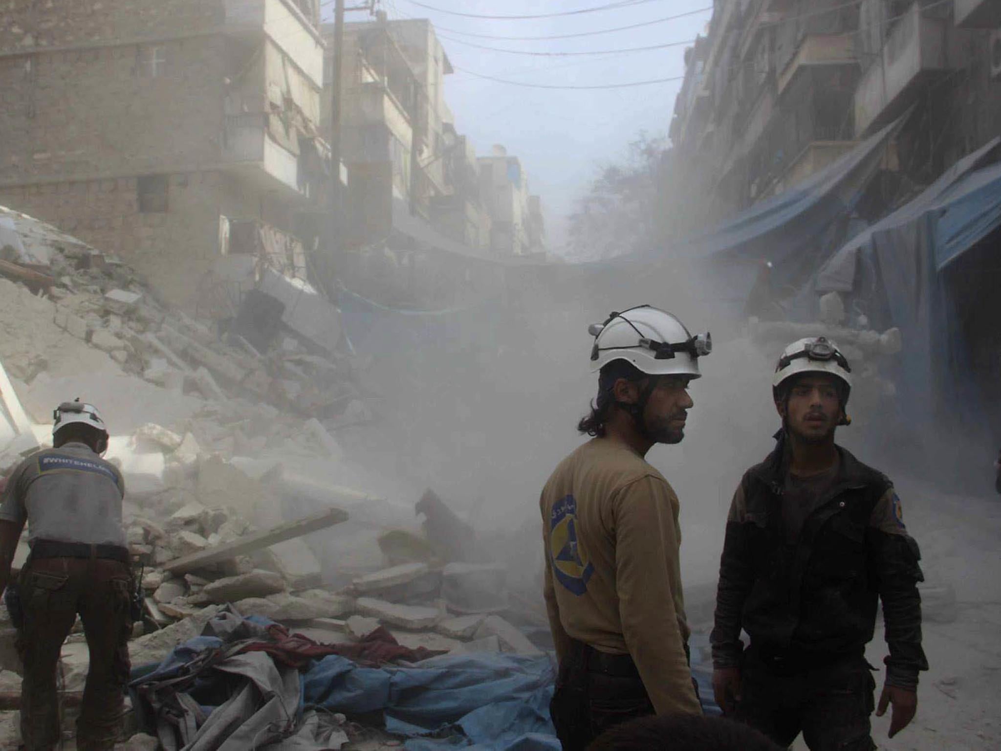 Syrian Civil Defence workers search through rubble in rebel-held eastern Aleppo yesterday