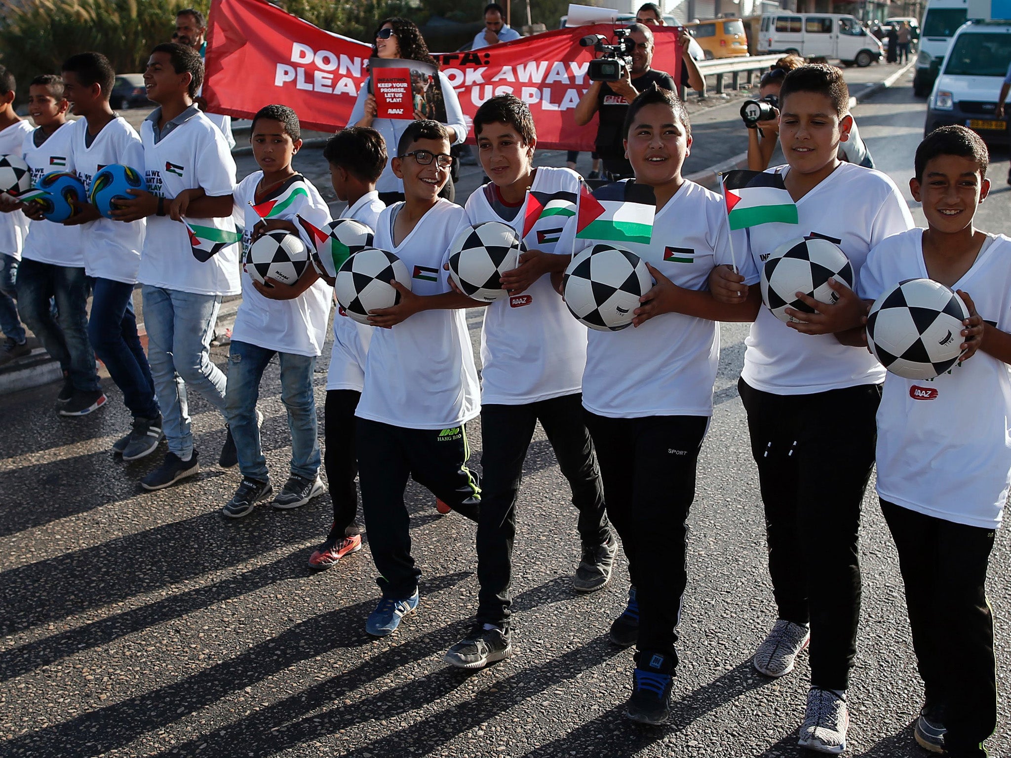 Palestine youths stage a protest to play on the settlements