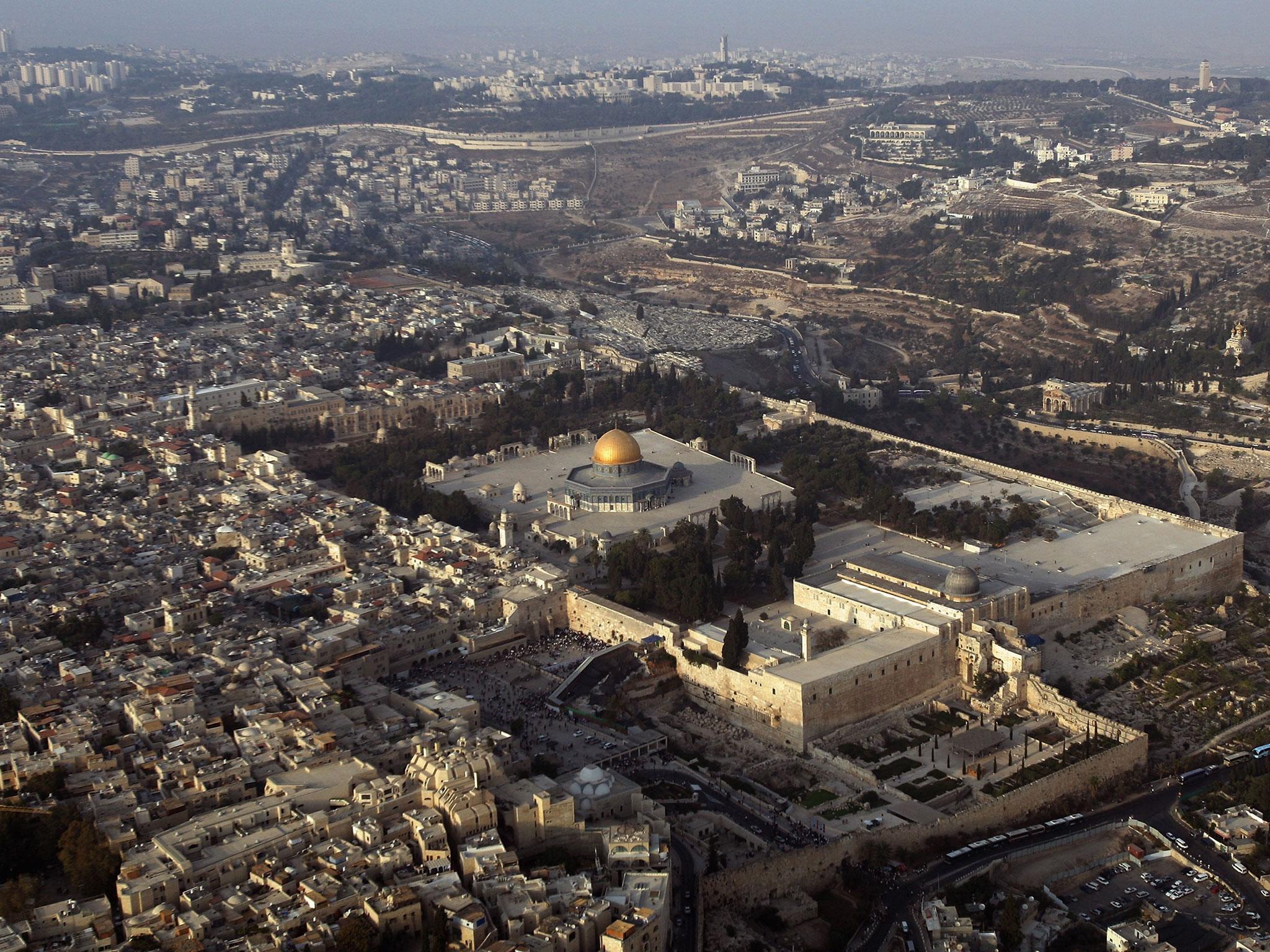 The Temple Mount, known to Muslims as el-Harem al-Sharif (the Noble Sanctuary) with its golden Dome of the Rock Islamic shrine and lead-domed al-Aqsa mosque, dominates this aerial view of the Old City of Jerusalem, 2 October, 2007 (Getty)