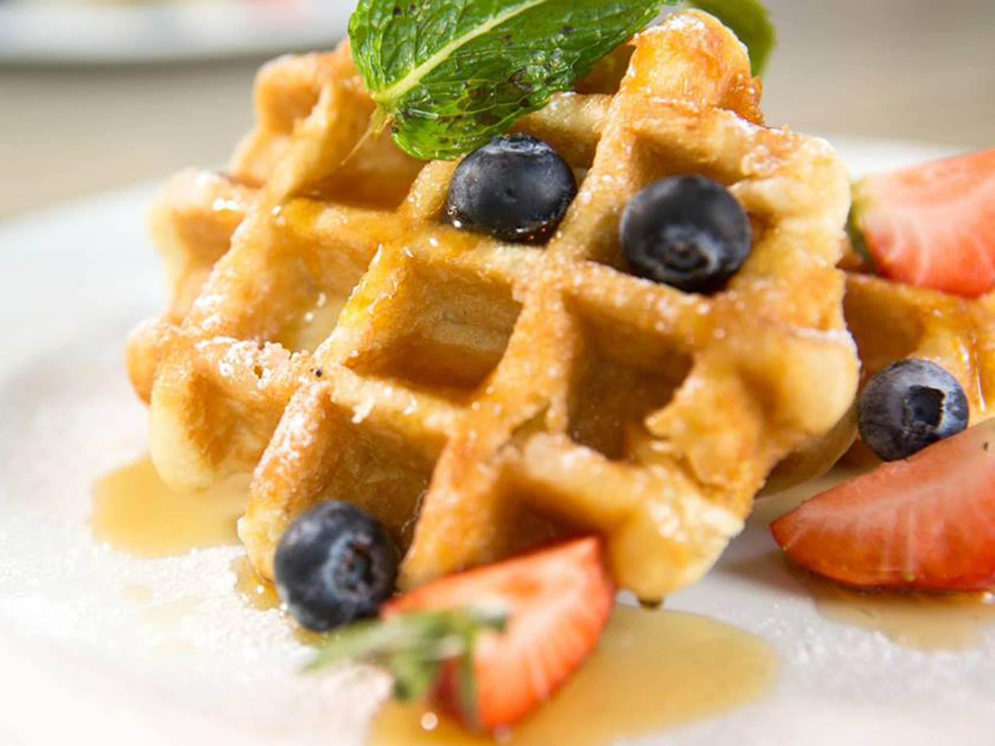 The menu includes brunch classics from Belgian waffles to French toast
