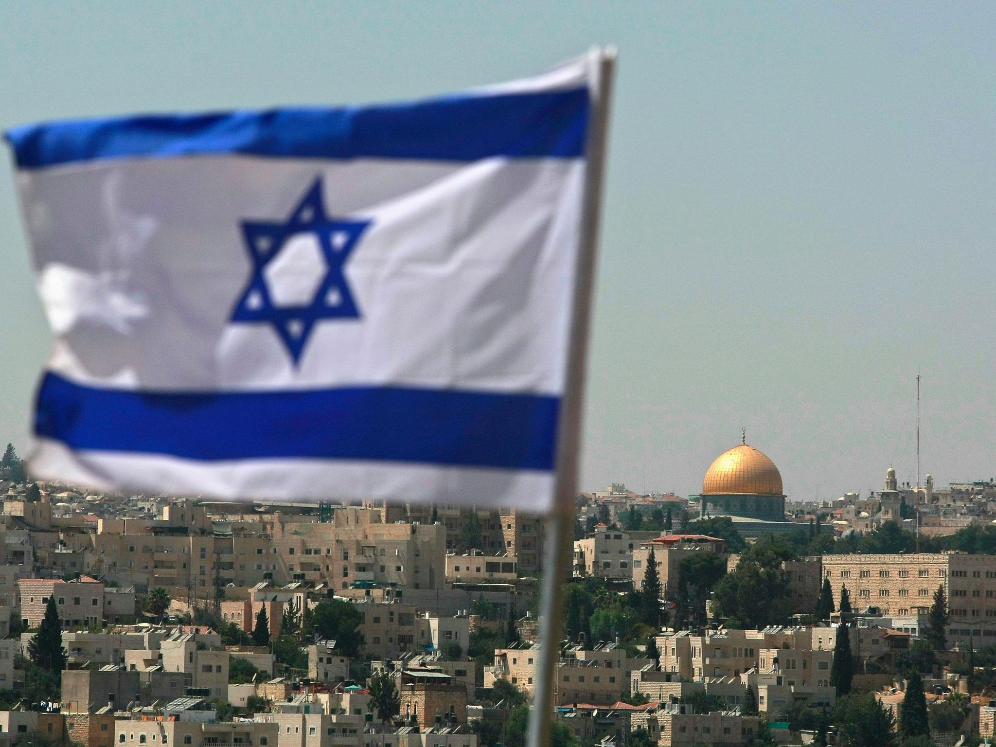 An Israeli flag flies from the Kidmat Zion Jewish settlement community on the outskirts of the Arab village of Abu Dis