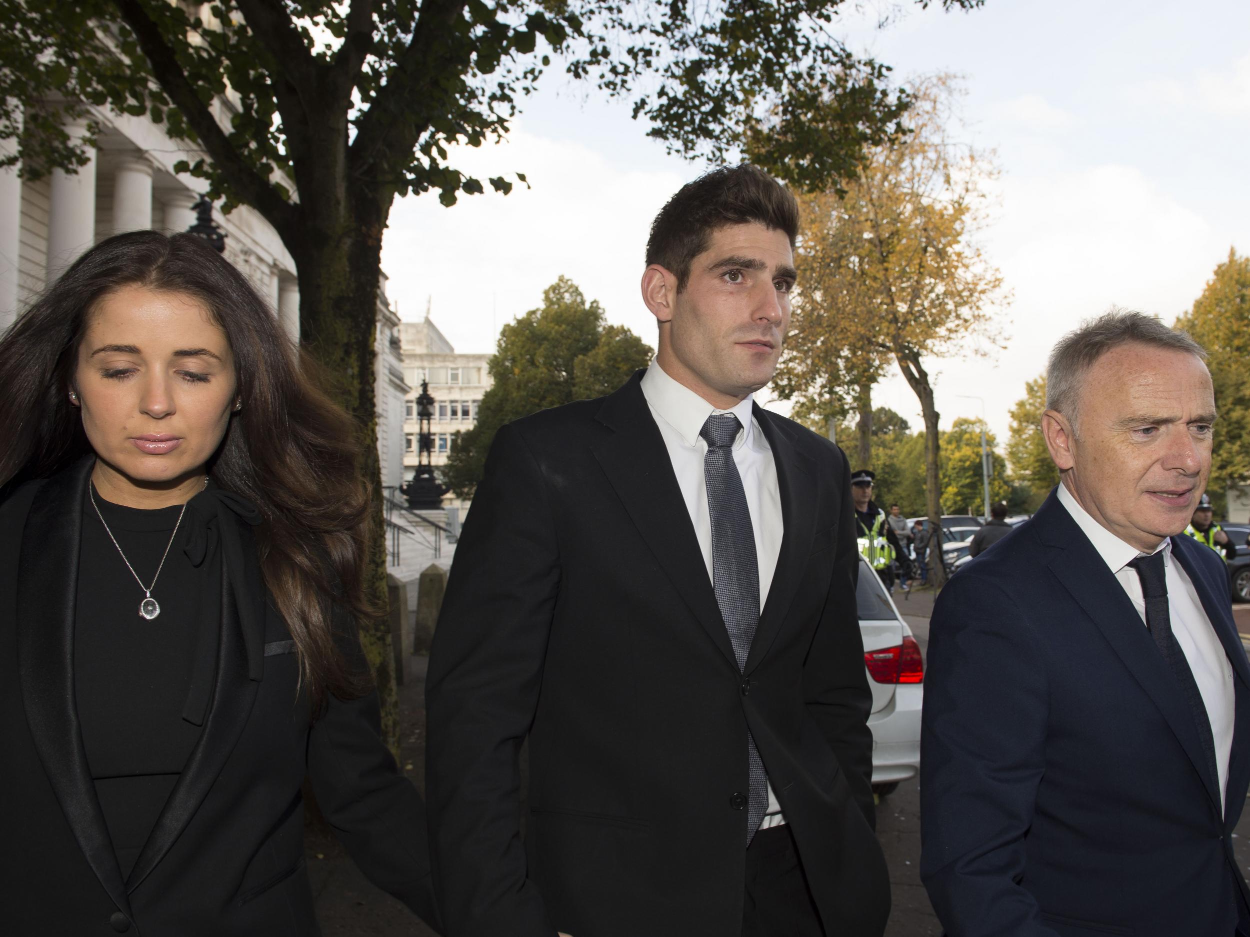 Chesterfield FC football player Ched Evans leaves Cardiff Crown Court with partner Natasha Massey after being found not guilty of rape