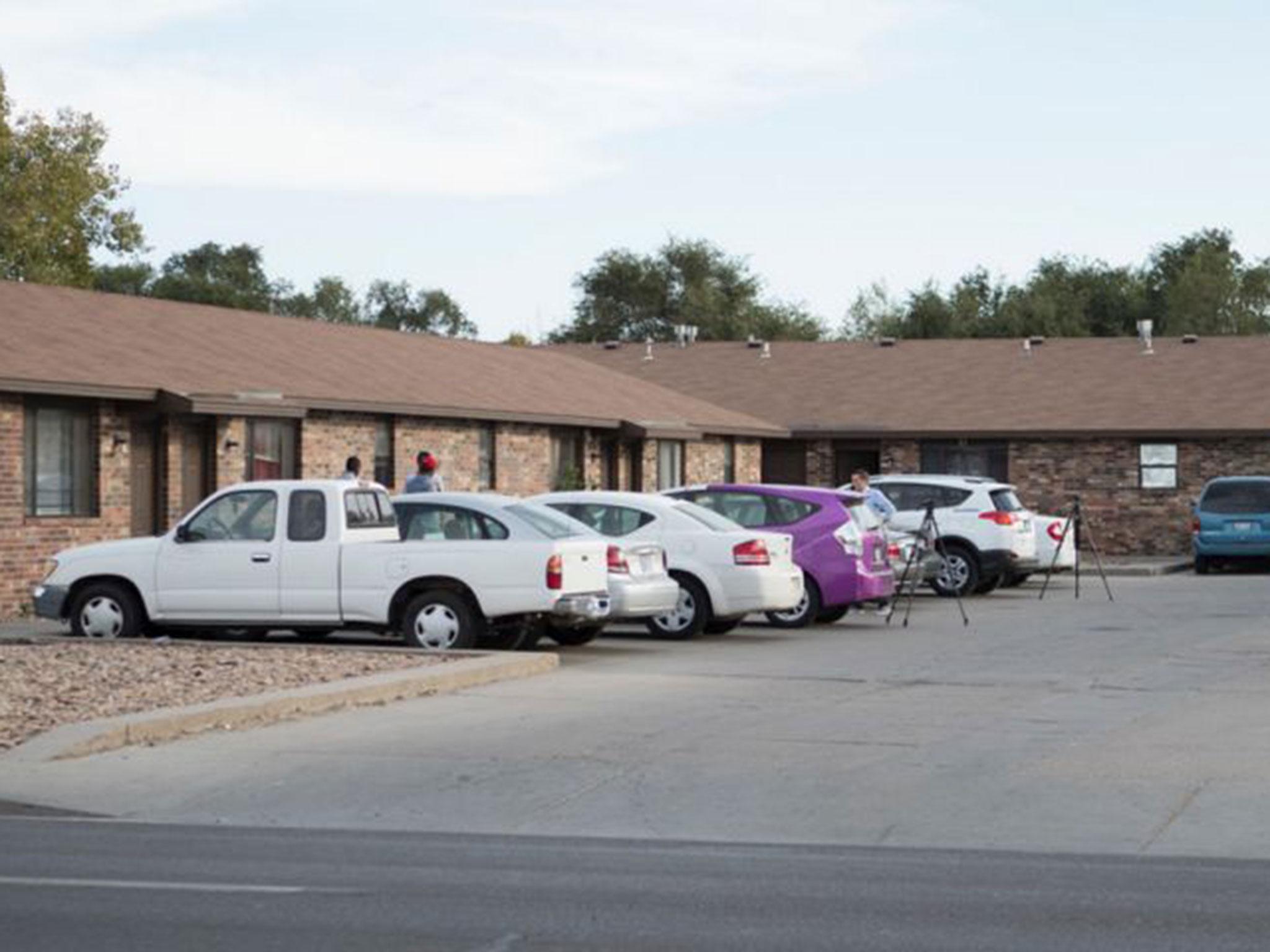 People stand outside the mosque located within the apartment complex, allegedly targeted by three Kansas militiamen