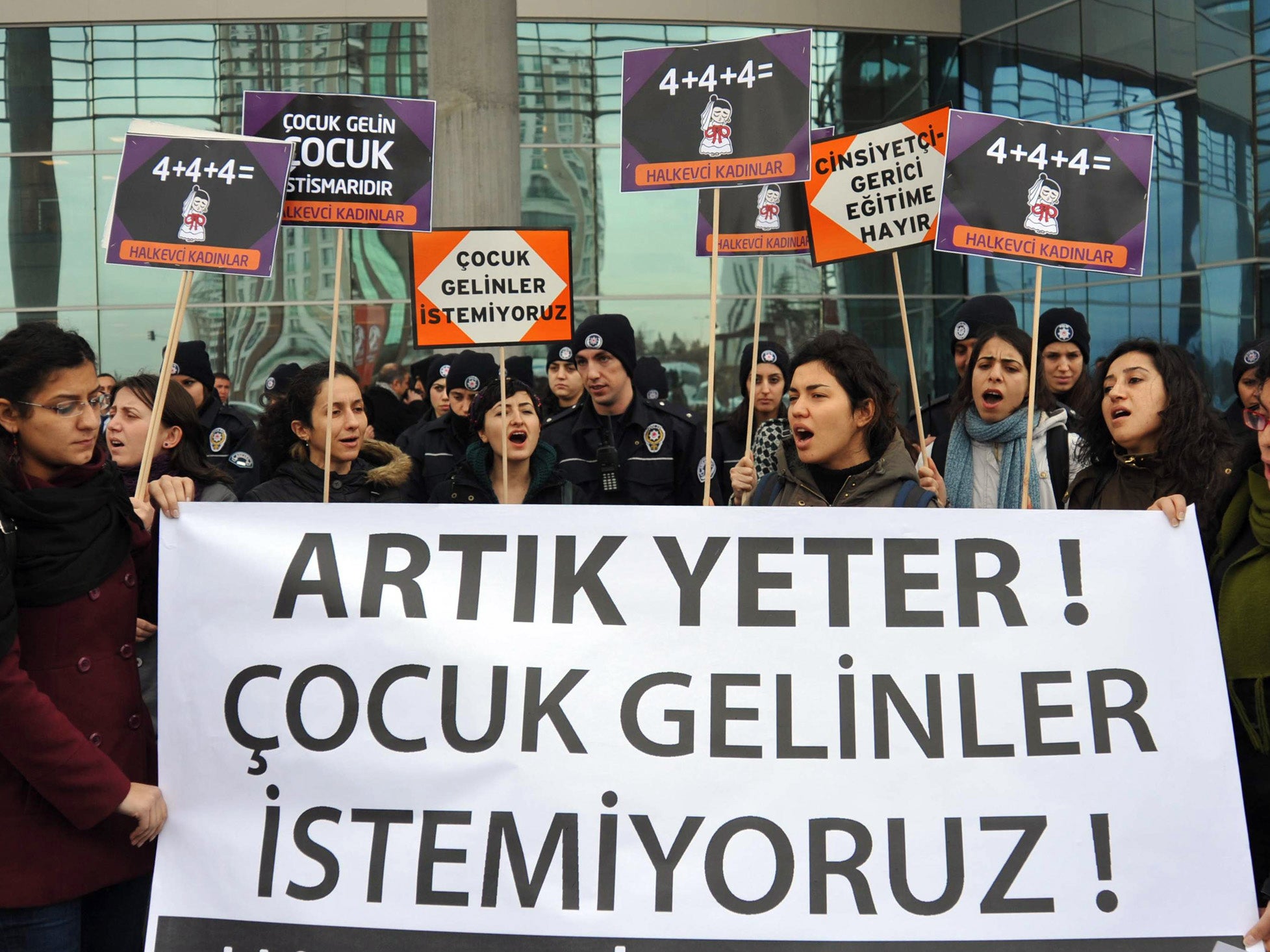 Demonstrators hold a banner reading ''Enough, we don't want child brides'' in Ankara