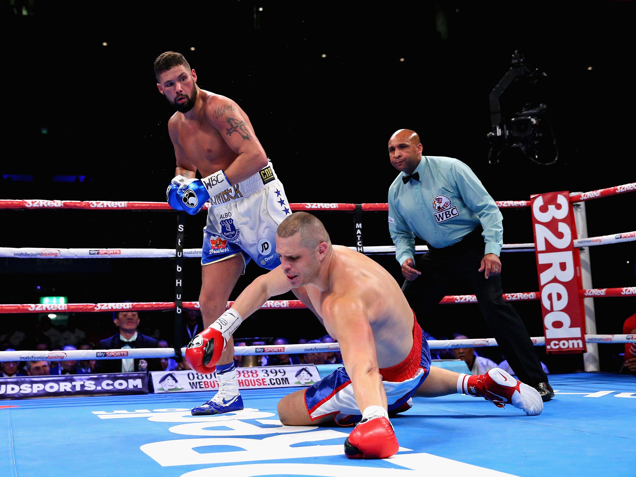 Tony Bellew knocks down BJ Flores during their contest for the WBC cruiserweight title