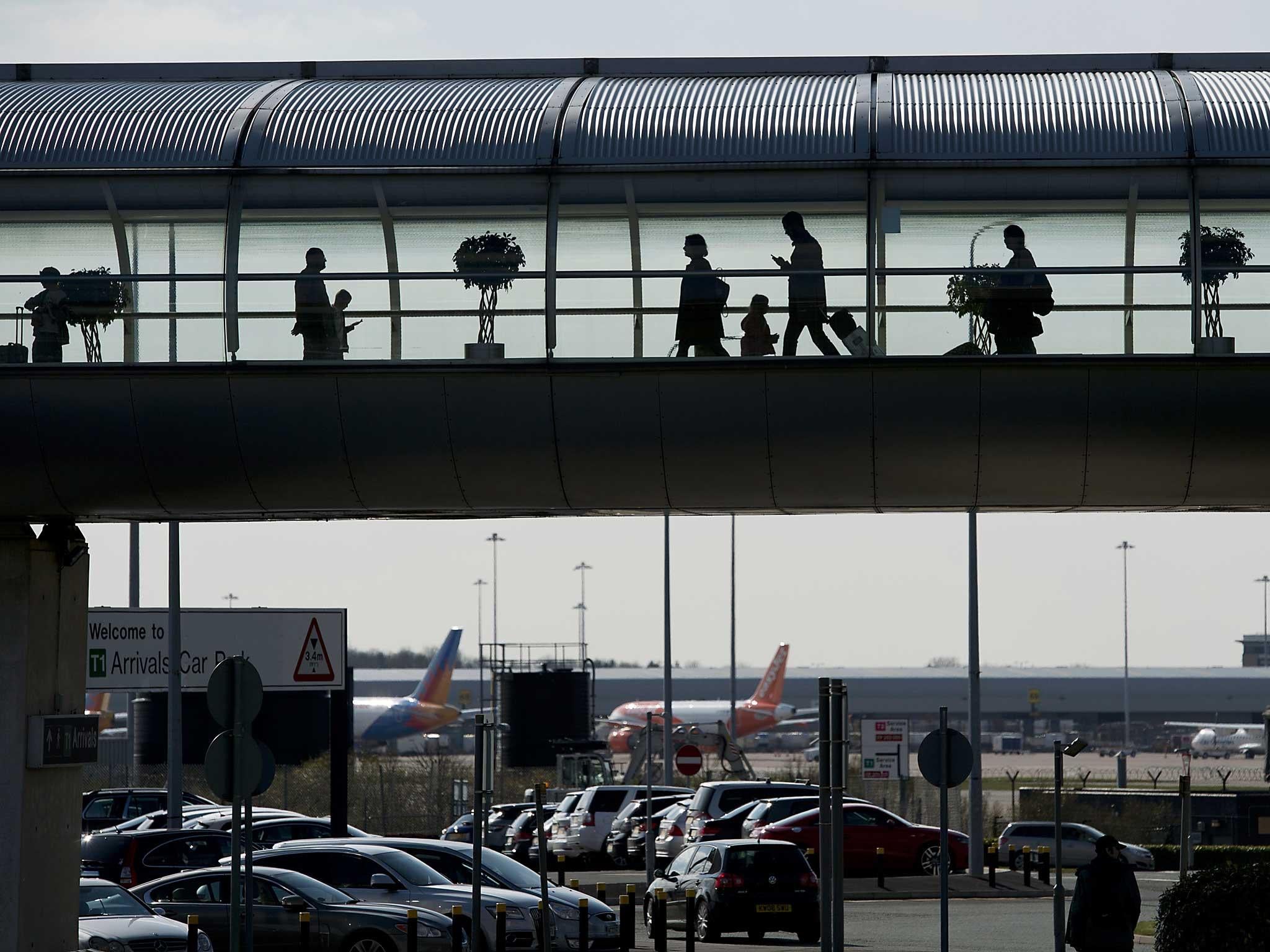 Passengers make their way through a terminal building at Manchester Airport