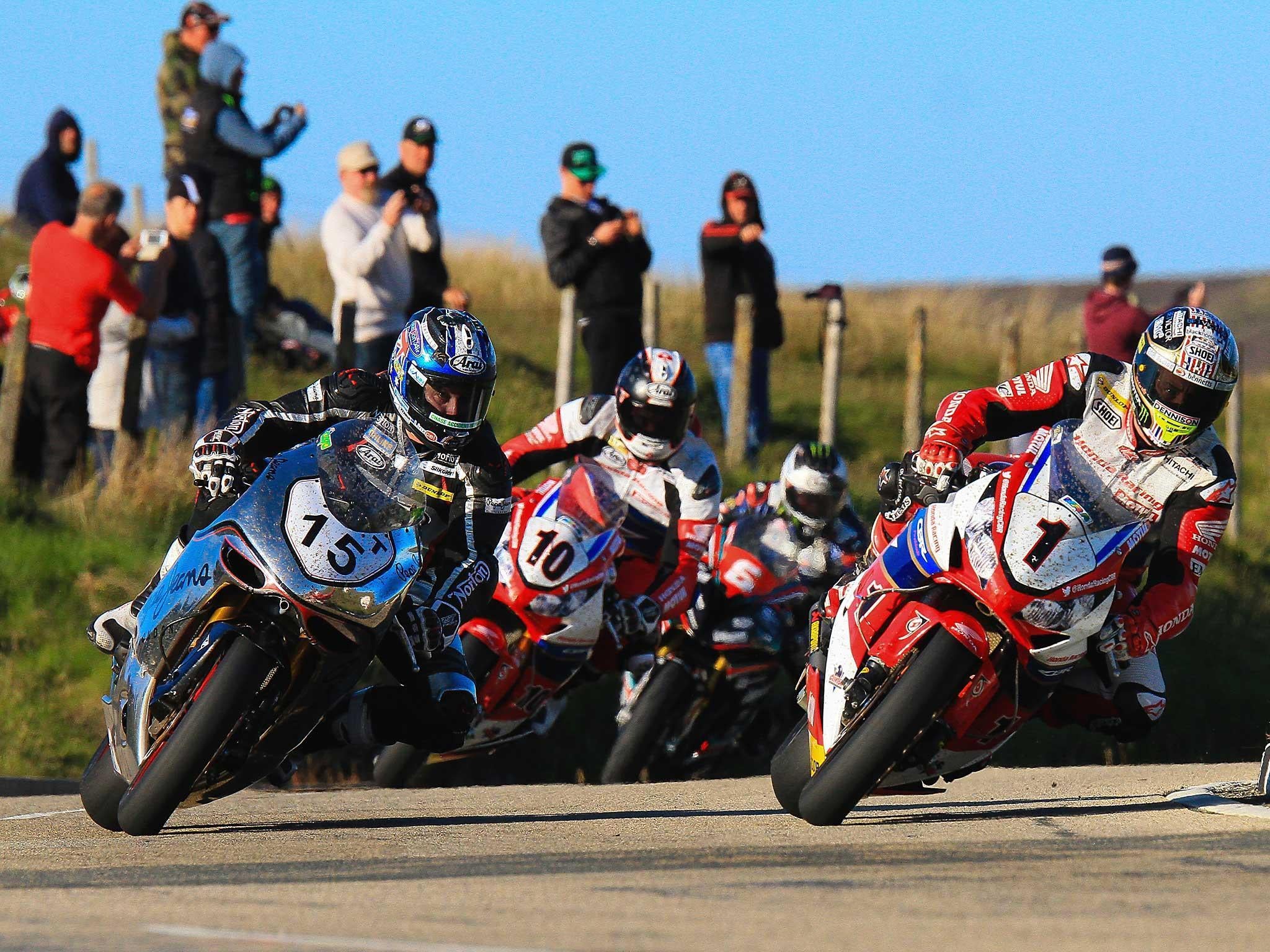 John McGuiness, right, in the lead over the mountain section at the Isle of Man TT race